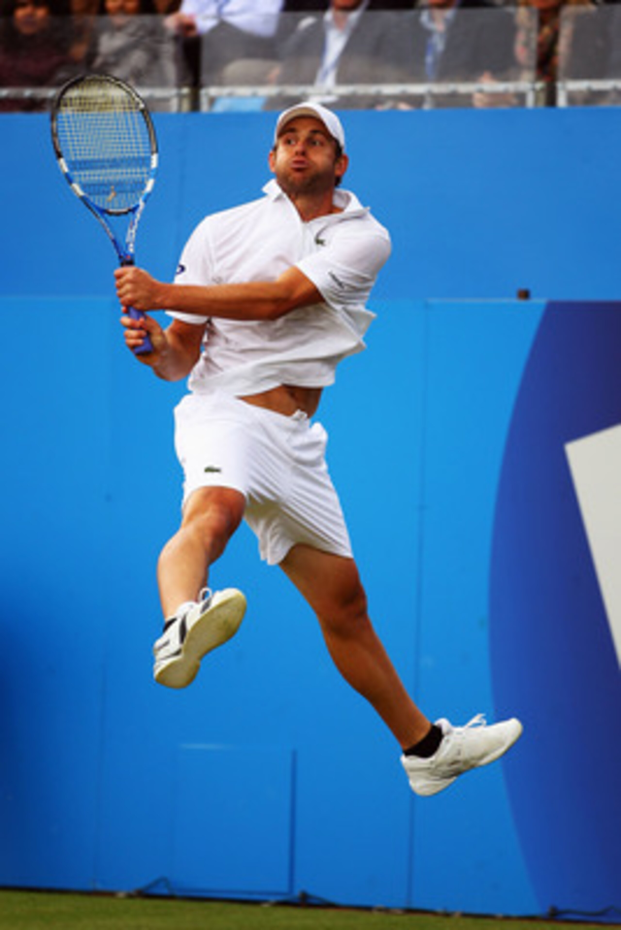 LONDON, ENGLAND - JUNE 10: Andy Roddick of the United States jumps for the return during his Men's Singles quarter final match against Fernando Verdasco of Spain on day five of the AEGON Championships at Queens Club on June 10, 2011 in London, England. LONDON, ENGLAND - JUNE 10: Andy Roddick of the United States jumps for the return during his Men's Singles quarter final match against Fernando Verdasco of Spain on day five of the AEGON Championships at Queens Club on June 10, 2011 in London, England.
