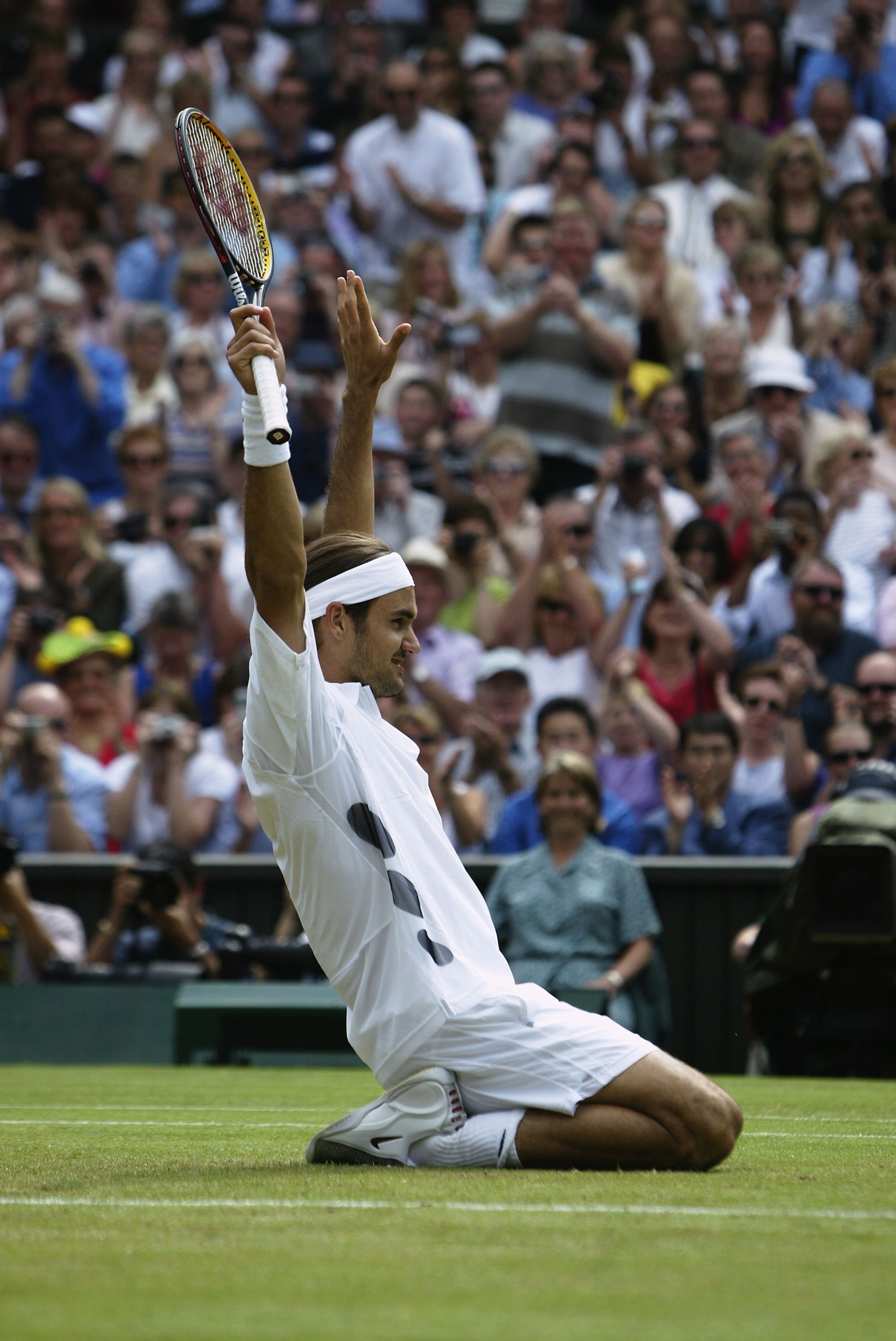 LONDON - JULY 6: Roger Federer of Switzerland celebrates after his victory over Mark Philippoussis of Australia in the Men's Singles Final during the final day of the Wimbledon Lawn Tennis Championships held on July 6, 2003 at the All England Lawn Tennis LONDON - JULY 6: Roger Federer of Switzerland celebrates after his victory over Mark Philippoussis of Australia in the Men's Singles Final during the final day of the Wimbledon Lawn Tennis Championships held on July 6, 2003 at the All England Lawn Tennis