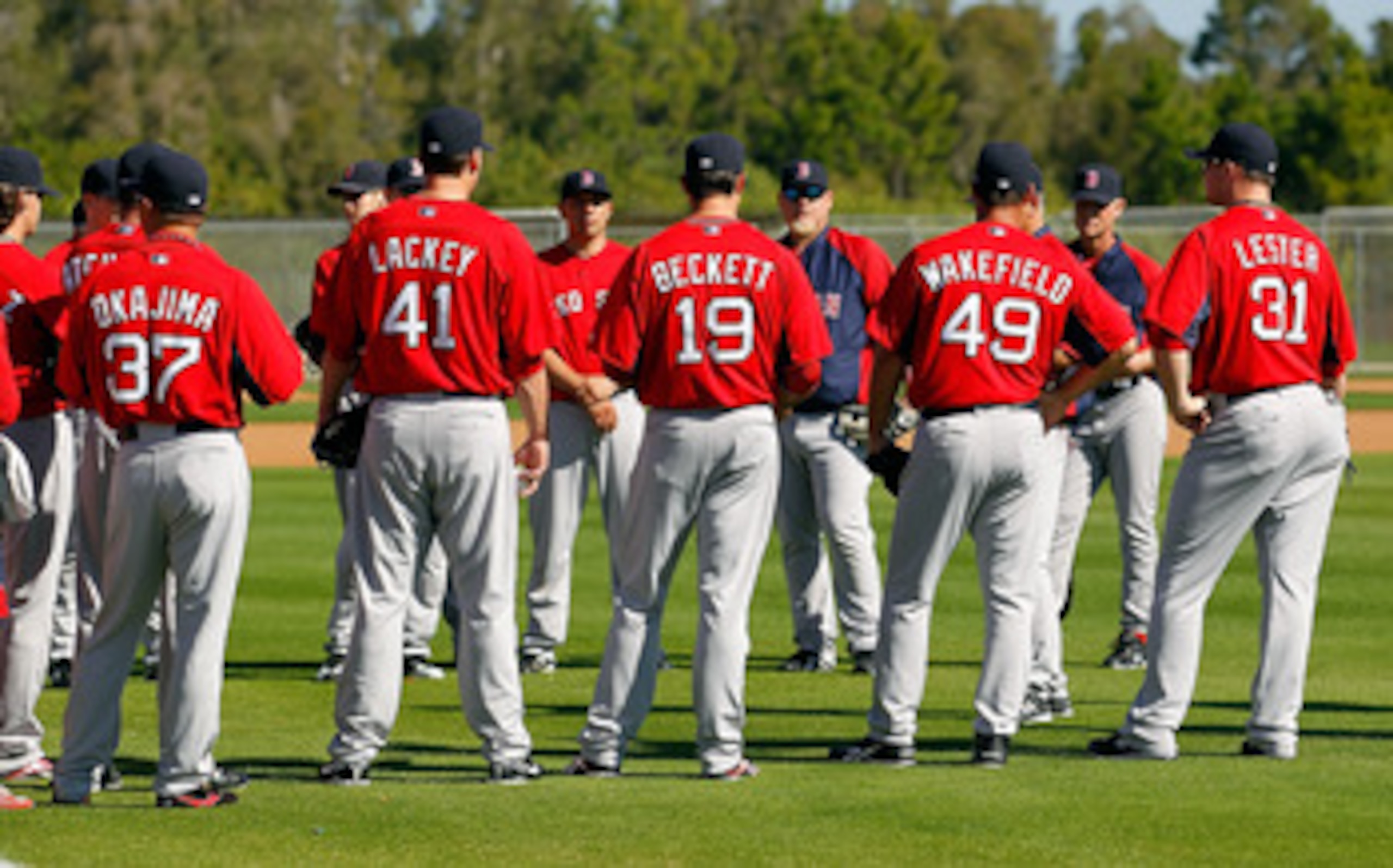 FORT MYERS, FL - FEBRUARY 19:  Pitchers Hideki Okajima #37, John Lackey #41, Josh Beckett #19, Tim Wakefield #49 and Jon Lester #31 of the Boston Red Sox talk with coaches during a Spring Training Workout Session at the Red Sox Player Development Complex 