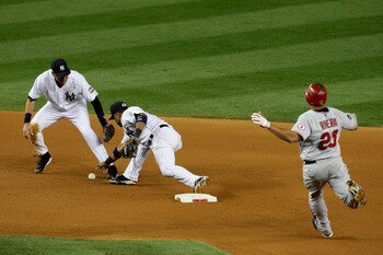 NEW YORK - OCTOBER 25:  Robinson Cano #24 of the New York Yankees forces out Juan Rivera #20 of the Los Angeles Angels of Anaheim on a fielder's choice in the top of the seventh inning of Game Six of the ALCS during the 2009 MLB Playoffs at Yankee Stadium