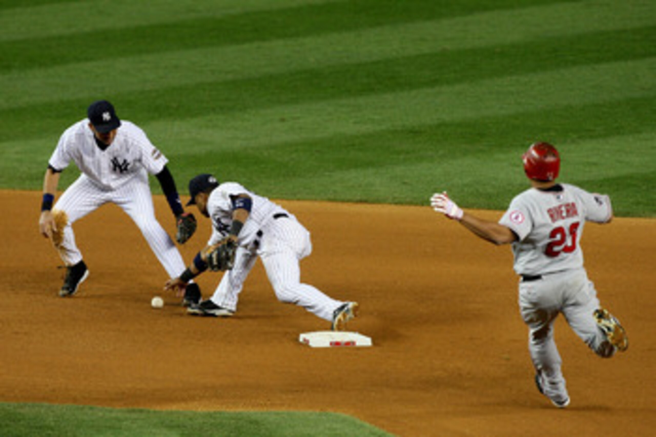NEW YORK - OCTOBER 25:  Robinson Cano #24 of the New York Yankees forces out Juan Rivera #20 of the Los Angeles Angels of Anaheim on a fielder's choice in the top of the seventh inning of Game Six of the ALCS during the 2009 MLB Playoffs at Yankee Stadium