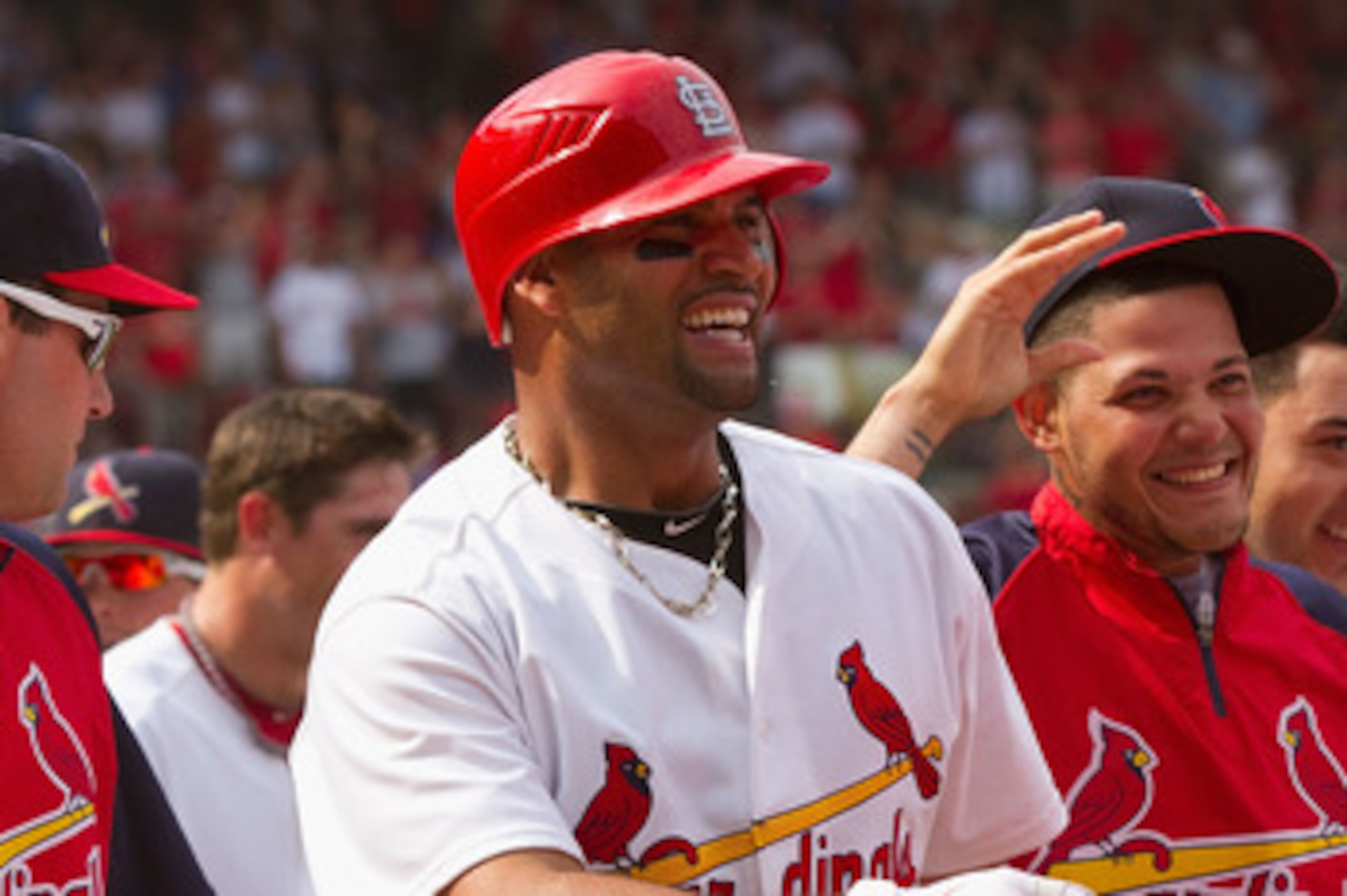 ST. LOUIS, MO - JUNE 5: Albert Pujols #5 and Yadier Molina #4 both of the St. Louis Cardinals leave the field after Pujols' walk-off home run against the Chicago Cubs with teammates at Busch Stadium on June 5, 2011 in St. Louis, Missouri.  The Cardinals b