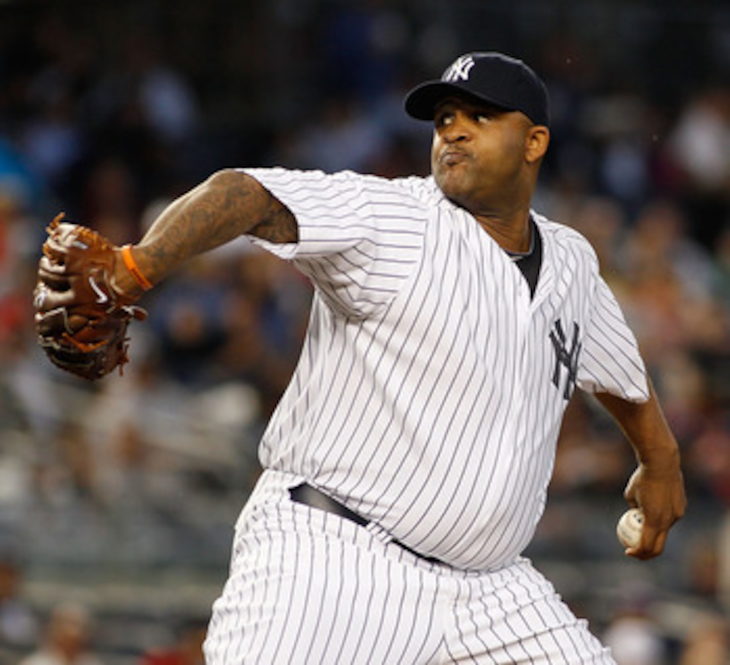 NEW YORK - JUNE 14:  CC Sabathia #52 of the New York Yankees delivers a pitch against the Texas Rangers on June 14, 2011 at Yankee Stadium in the Bronx borough of New York City.  (Photo by Mike Stobe/Getty Images)