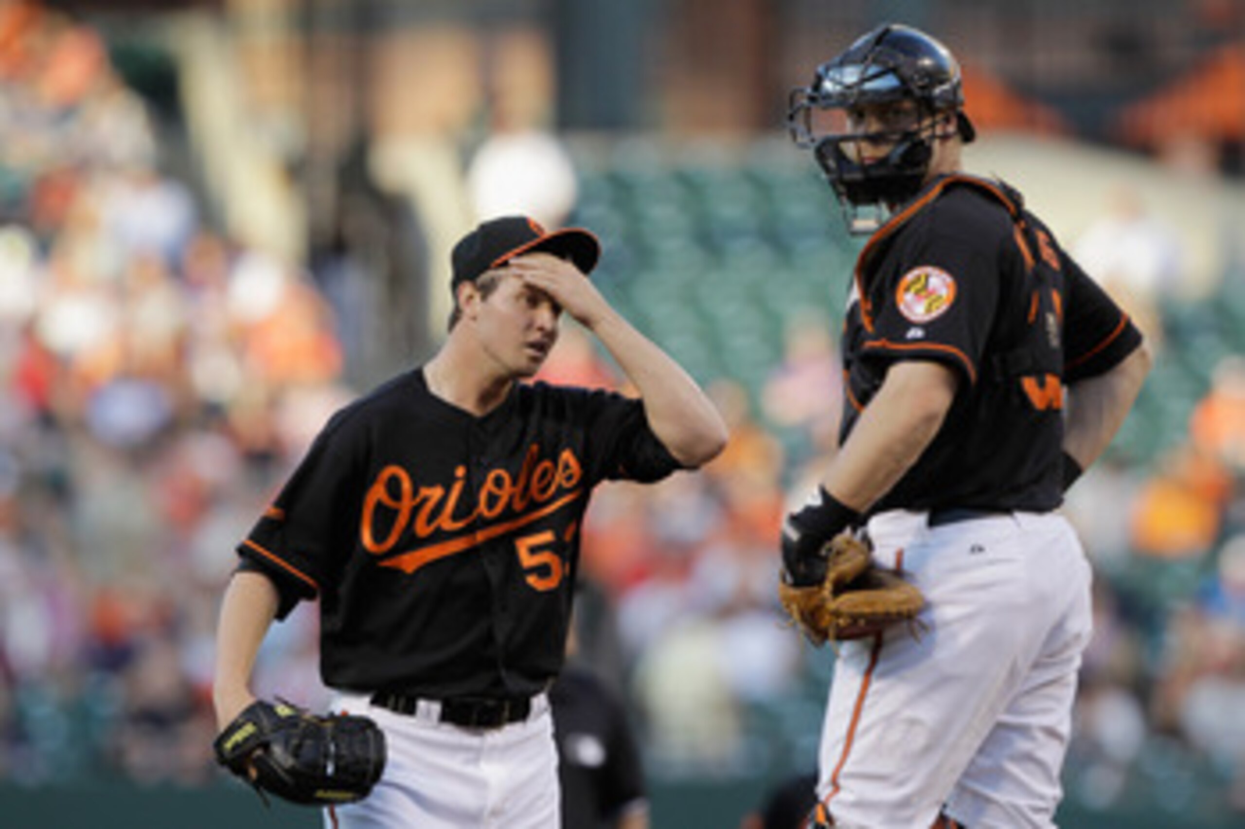 BALTIMORE, MD - JUNE 03:  Starting pitcher Zach Britton #53 of the Baltimore Orioles talks with catcher Matt Wieters #32 after giving up a run in the second inning to the Toronto Blue Jays at Oriole Park at Camden Yards on June 3, 2011 in Baltimore, Maryl