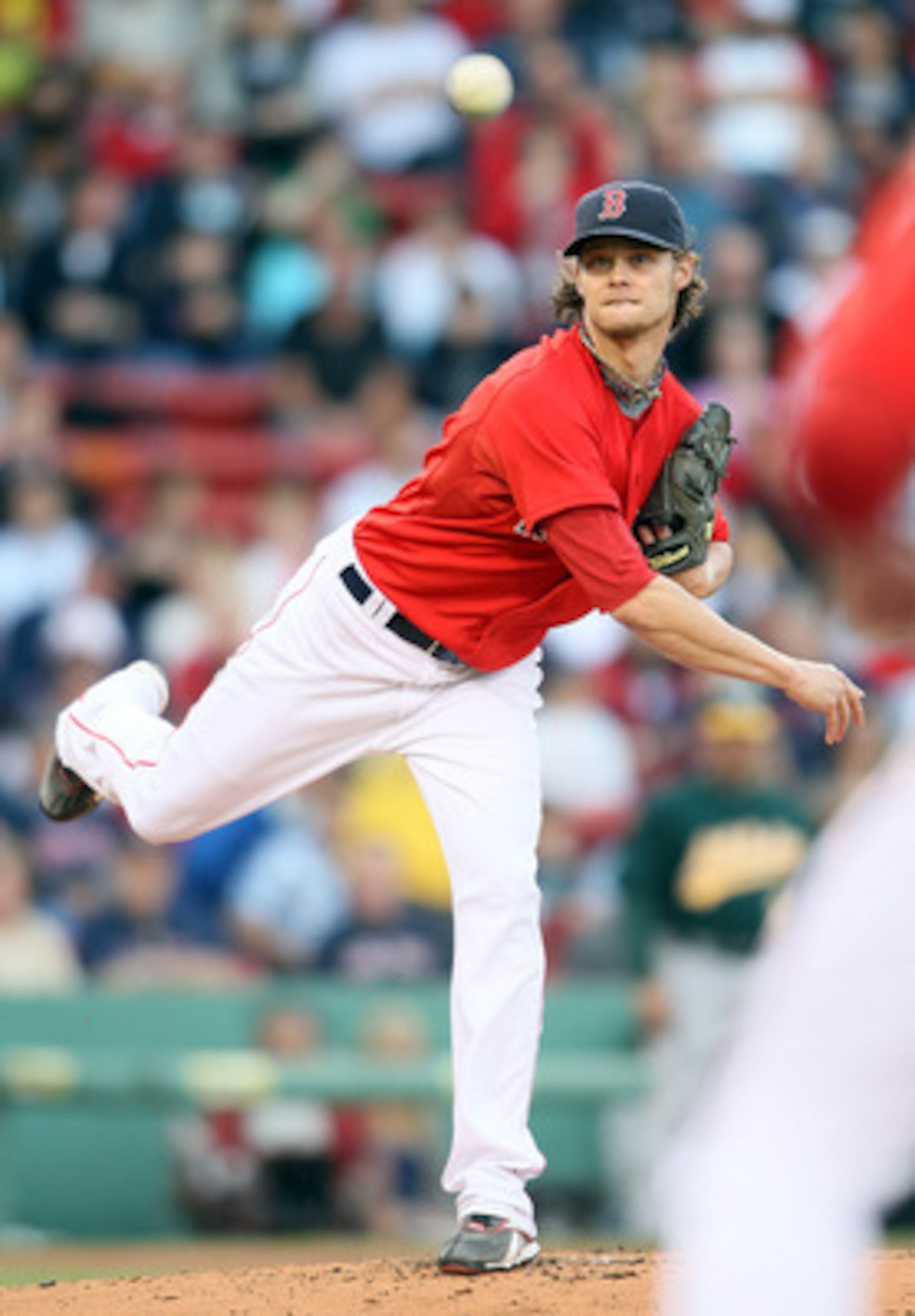 BOSTON, MA - JUNE 03:  Clay Buchholz #11 of the Boston Red Sox sends the ball to first to try and pick of David DeJesus of the Oakland Athletics on June 3, 2011 at Fenway Park in Boston, Massachusetts.  (Photo by Elsa/Getty Images)