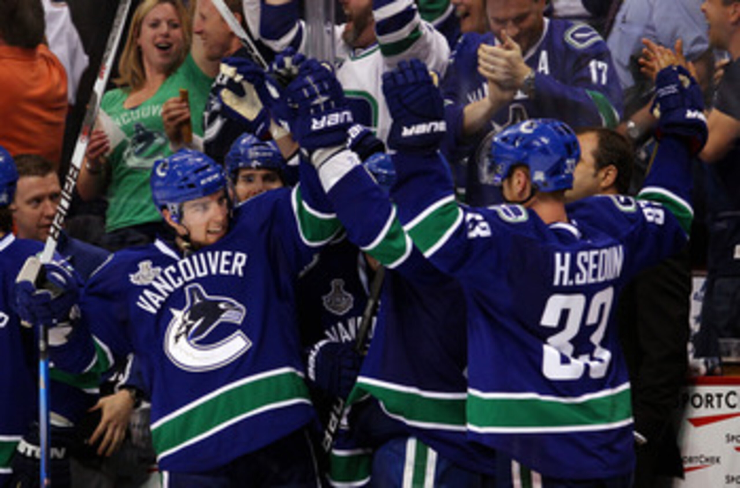 VANCOUVER, BC - JUNE 10:  Alex Burrows #14 and Henrik Sedin #33 of the Vancouver Canucks celebrate after a goal in the third period during Game Five of the 2011 NHL Stanley Cup Final at Rogers Arena on June 10, 2011 in Vancouver, British Columbia, Canada.