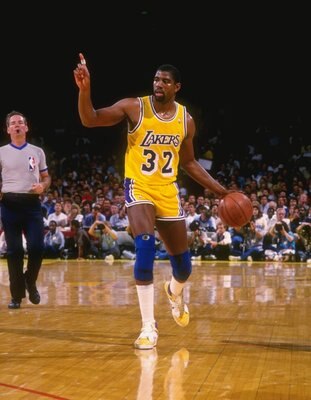 1987:  Point guard Magic Johnson of the Los Angeles Lakers dribbles the ball down the court during a game at the Great Western Forum in Inglewood, California.   Mandatory Credit: Allsport  /Allsport