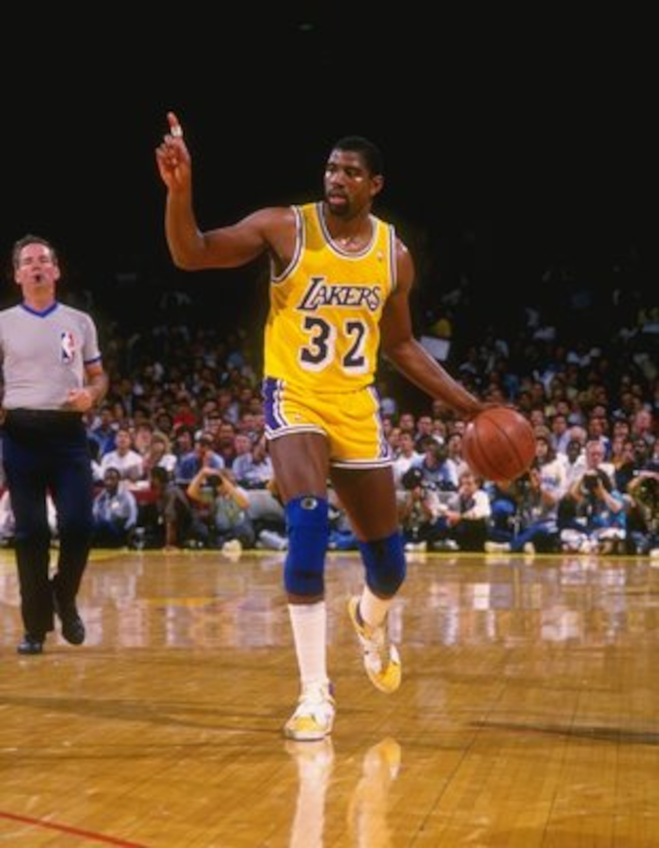 1987:  Point guard Magic Johnson of the Los Angeles Lakers dribbles the ball down the court during a game at the Great Western Forum in Inglewood, California.   Mandatory Credit: Allsport  /Allsport