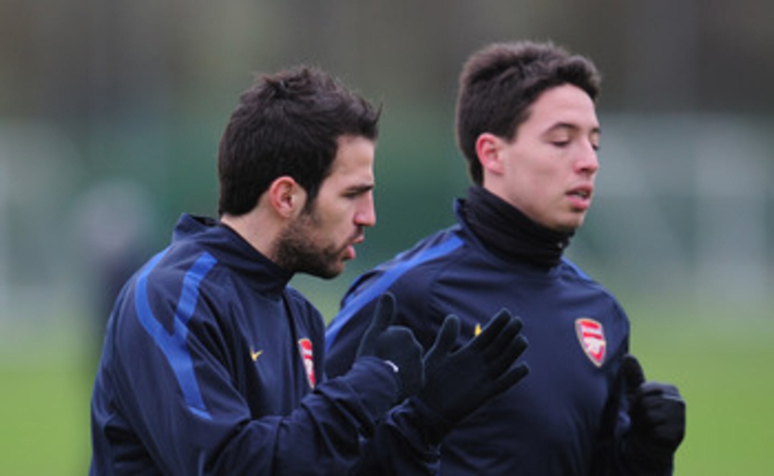 ST ALBANS, ENGLAND - FEBRUARY 15:  Cesc Fabregas and Samir Nasri of Arsenal warm-up during training at London Colney on February 15, 2011 in St Albans, England.  (Photo by Shaun Botterill/Getty Images)
