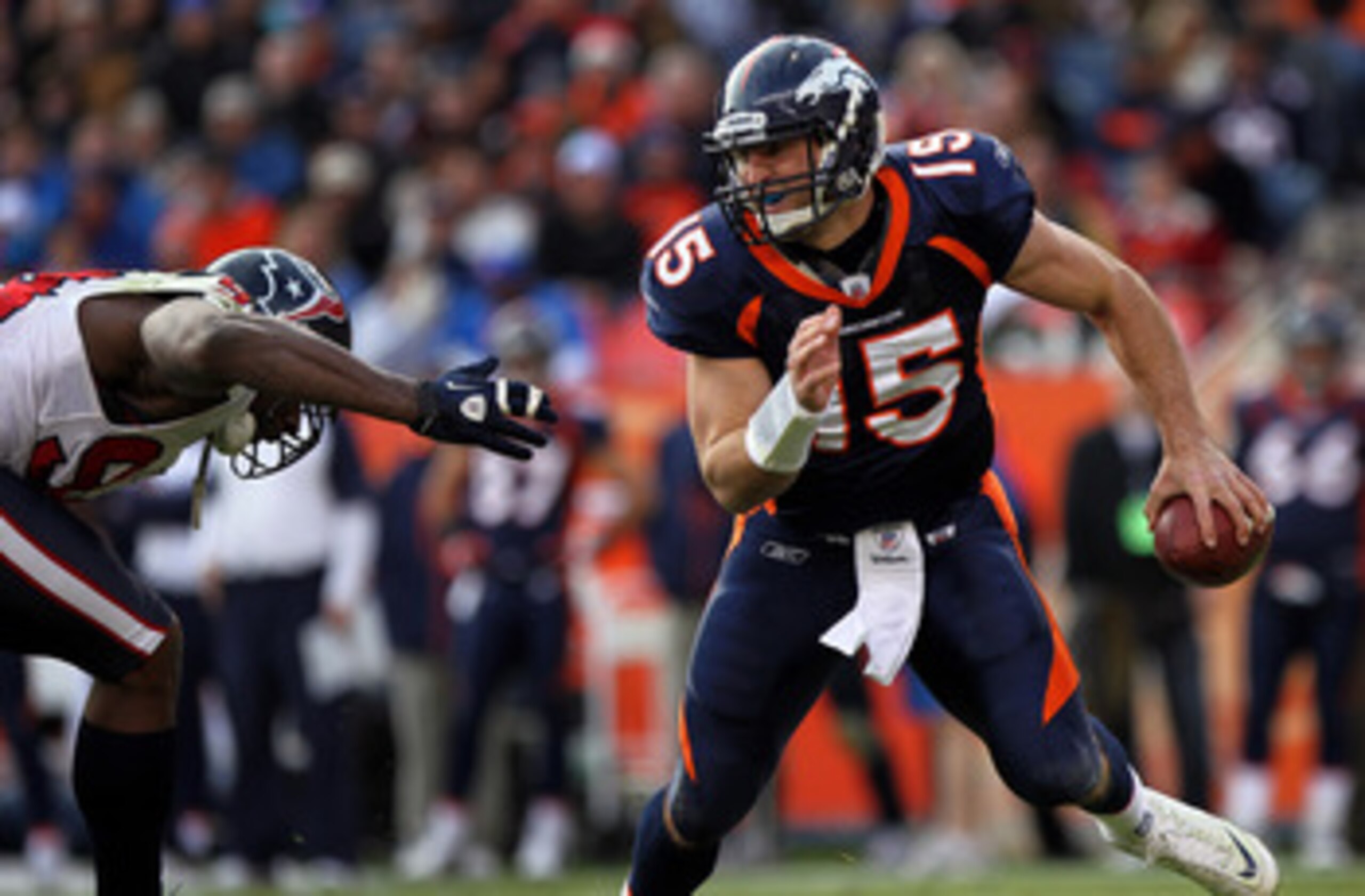 DENVER - DECEMBER 26:  Quarterback Tim Tebow #15 of the Denver Broncos rolls out and looks to deliver a pass against the Houston Texas at INVESCO Field at Mile High on December 26, 2010 in Denver, Colorado. The Broncos defeated the Texans 24-23.  (Photo b