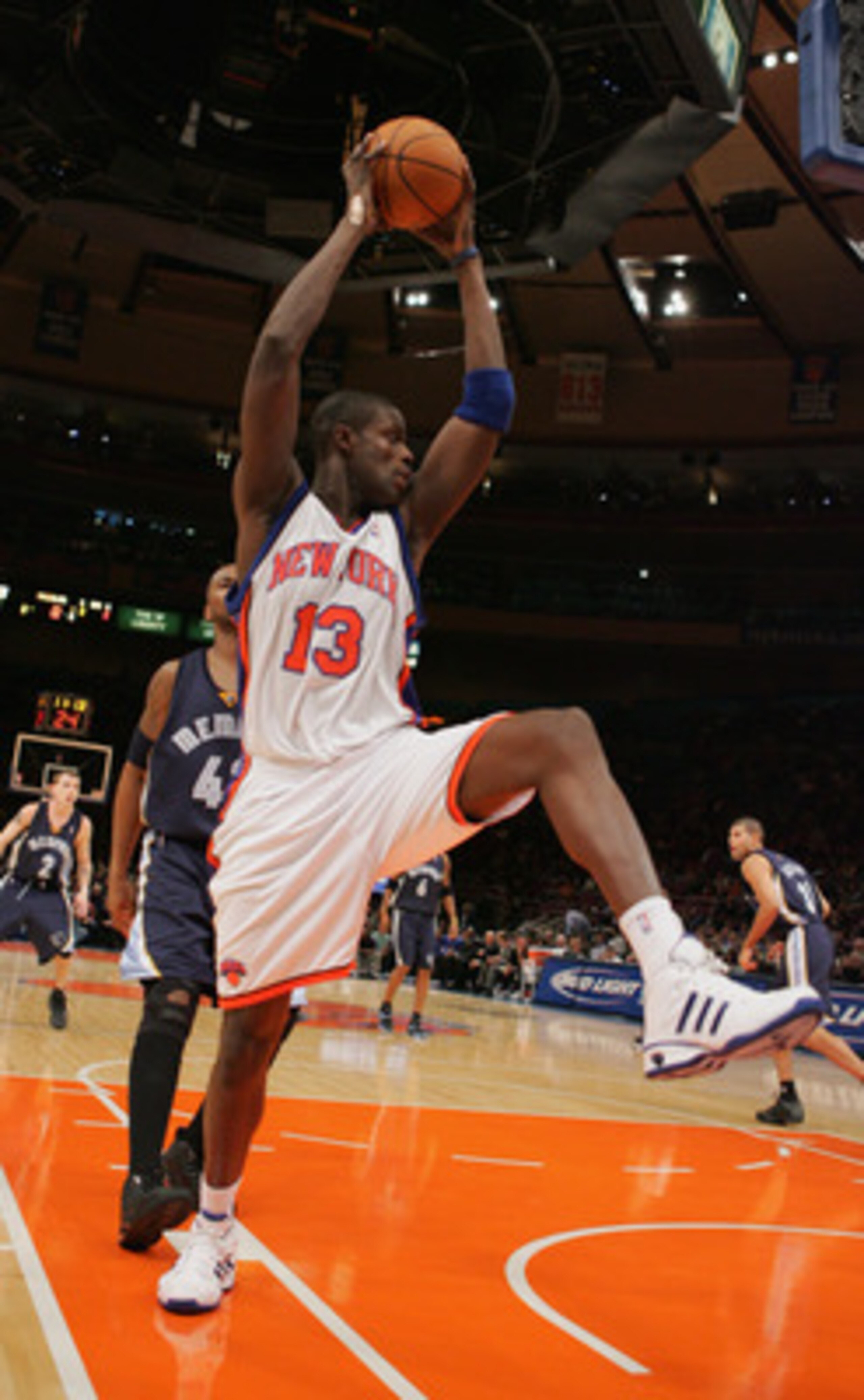 NEW YORK - DECEMBER 1:  Nazr Mohammed #13 of the New York Knicks rebounds against the Memphis Grizzlies December 1, 2004 at Madison Square Garden in New York, New York.  The Knicks won 90-82.  NOTE TO USER: User expressly acknowledges and agrees that, by