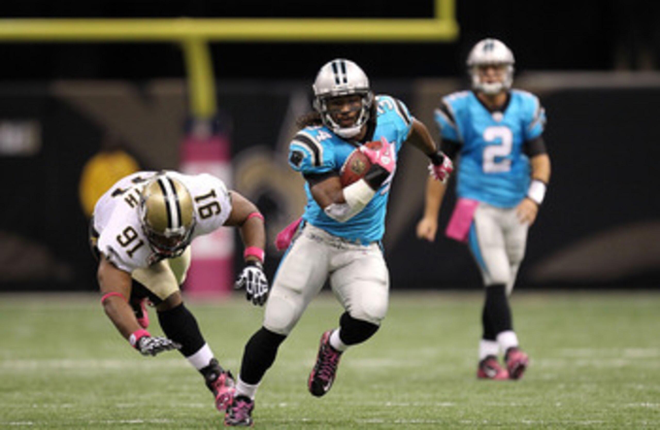 NEW ORLEANS - OCTOBER 03:  Running back DeAngelo Williams #34 of the Carolina Panthers runs for a touchdown past Will Smith #91 of the New Orleans Saints at the Louisiana Superdome on October 3, 2010 in New Orleans, Louisiana.  (Photo by Ronald Martinez/G