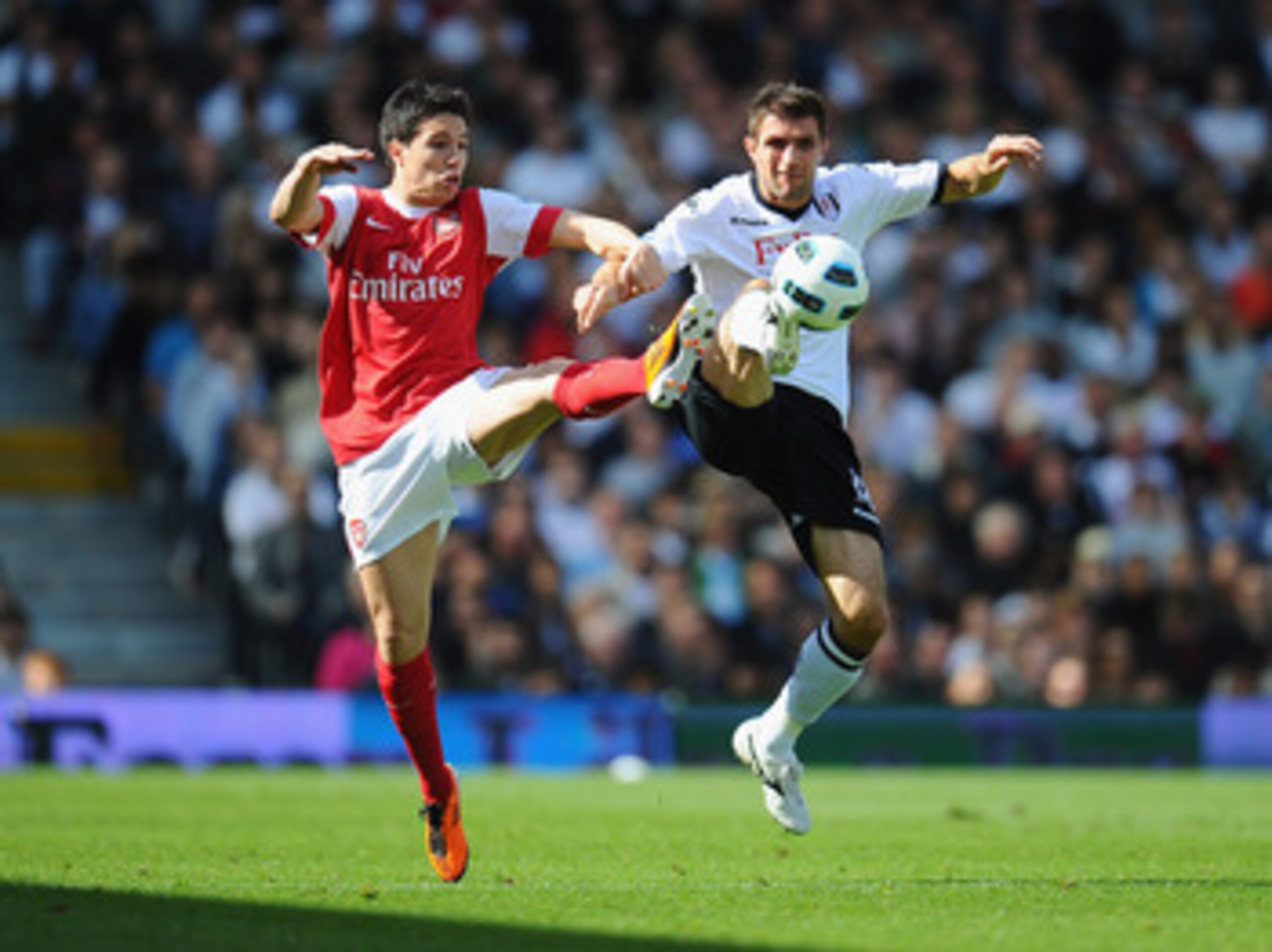 LONDON, ENGLAND - MAY 22:  Aaron Hughes of Fulham and Samir Nasri of Arsenal compete for the ball during the Barclays Premier League match between Fulham and Arsenal at Craven Cottage on May 22, 2011 in London, England.  (Photo by Clive Mason/Getty Images