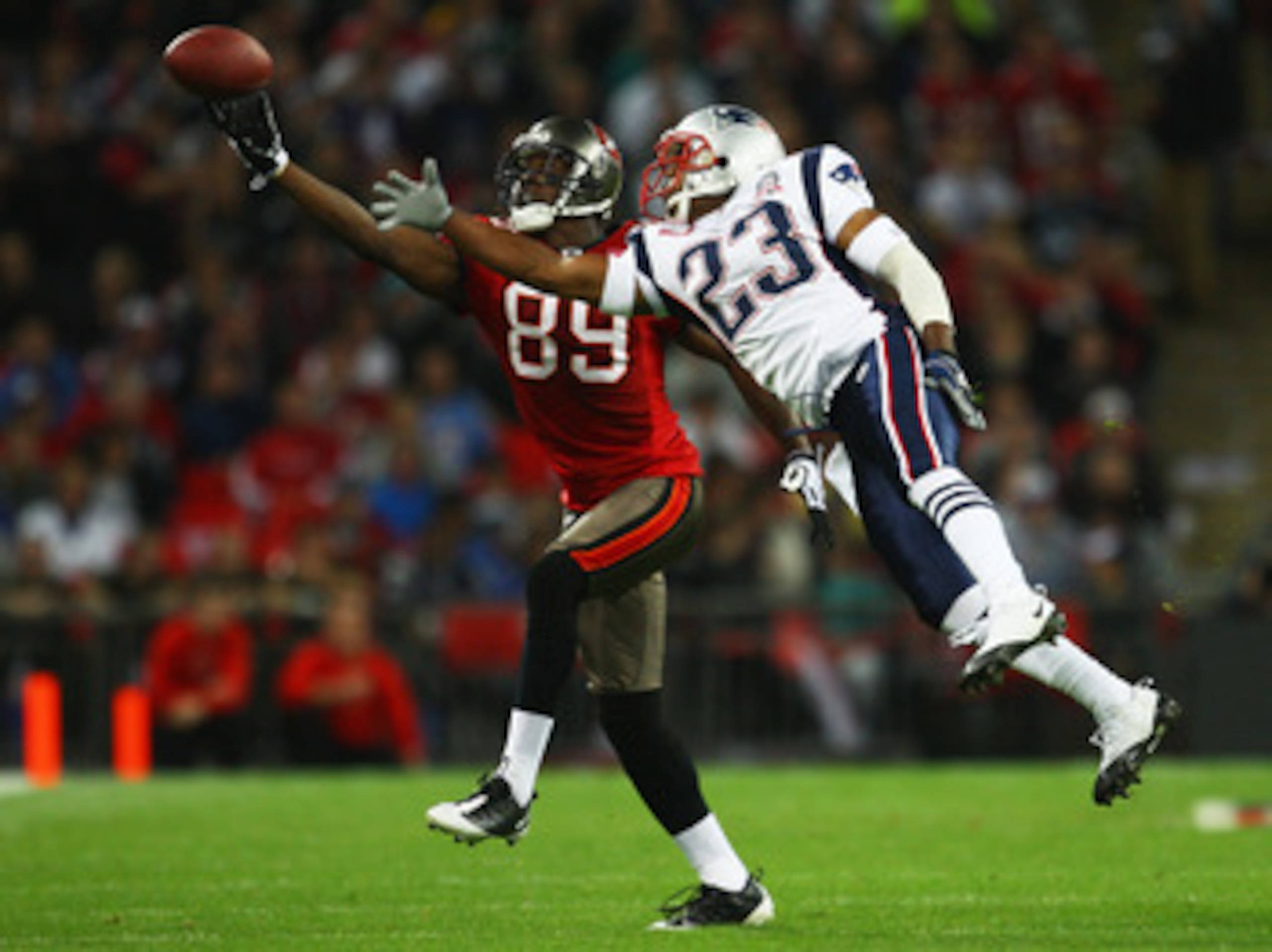 LONDON, ENGLAND - OCTOBER 25: Antonio Bryant (#89) of Tampa Bay Buccaneers and Leigh Bodden (#23) of the New England Patriots compete for the ball during the NFL International Series match between New England Patriots and Tampa Bay Buccaneers at Wembley LONDON, ENGLAND - OCTOBER 25: Antonio Bryant (#89) of Tampa Bay Buccaneers and Leigh Bodden (#23) of the New England Patriots compete for the ball during the NFL International Series match between New England Patriots and Tampa Bay Buccaneers at Wembley