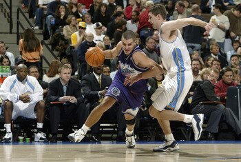 DENVER - JANUARY 9:  Aleksandar Pavlovic  #11 of the Utah Jazz moves the ball past Ryan Bowen #32 of the Denver Nuggets during the game on January 9, 2004 at the Pepsi Center in Denver, Colorado.  The Nuggets won 106-96. NOTE TO USER:  User expressly ackn