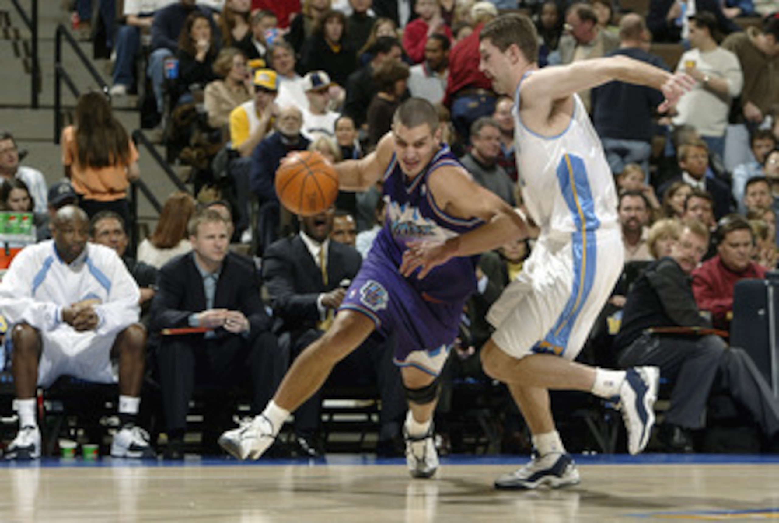DENVER - JANUARY 9:  Aleksandar Pavlovic  #11 of the Utah Jazz moves the ball past Ryan Bowen #32 of the Denver Nuggets during the game on January 9, 2004 at the Pepsi Center in Denver, Colorado.  The Nuggets won 106-96. NOTE TO USER:  User expressly ackn