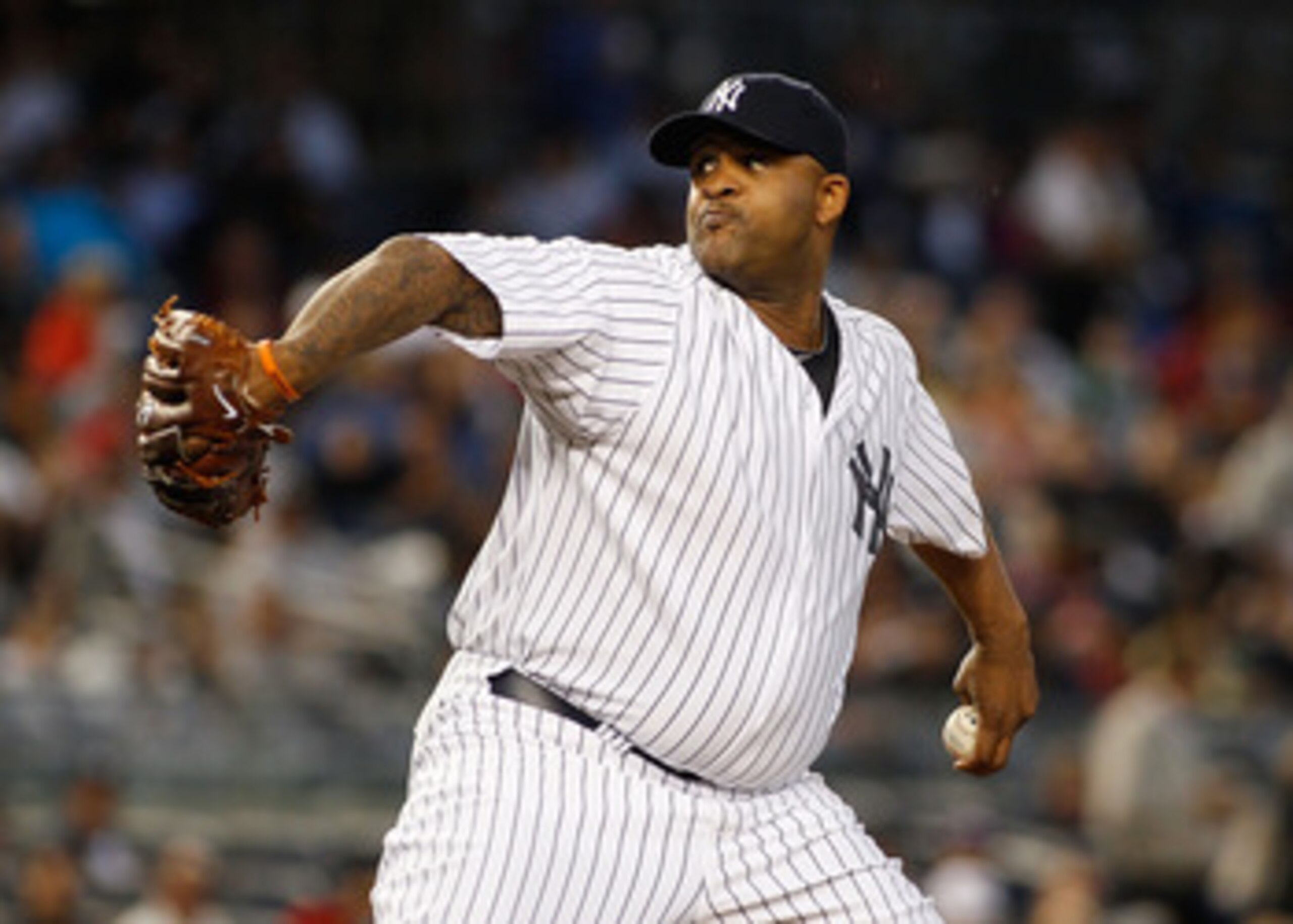 NEW YORK - JUNE 14:  CC Sabathia #52 of the New York Yankees delivers a pitch against the Texas Rangers on June 14, 2011 at Yankee Stadium in the Bronx borough of New York City.  (Photo by Mike Stobe/Getty Images)