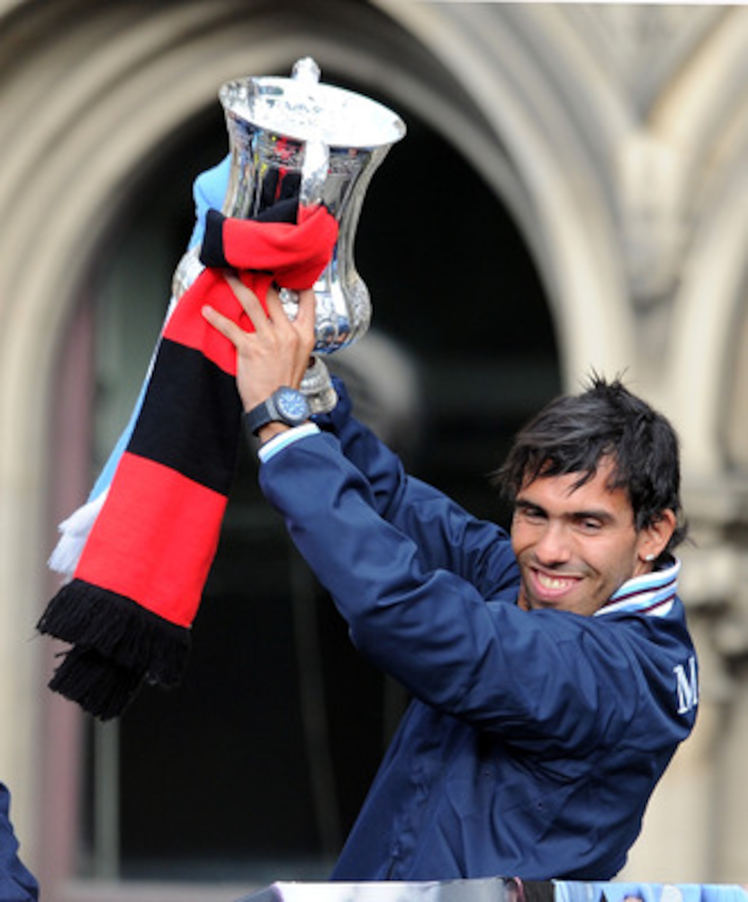 MANCHESTER, ENGLAND - MAY 23: Carlos Tevez of Manchester City lifts the FA Cup during the Manchester City FA Cup Winners Parade at Manchester Town Hall on May 23, 2011 in Manchester, United Kingdom.  (Photo by Chris Brunskill/Getty Images)