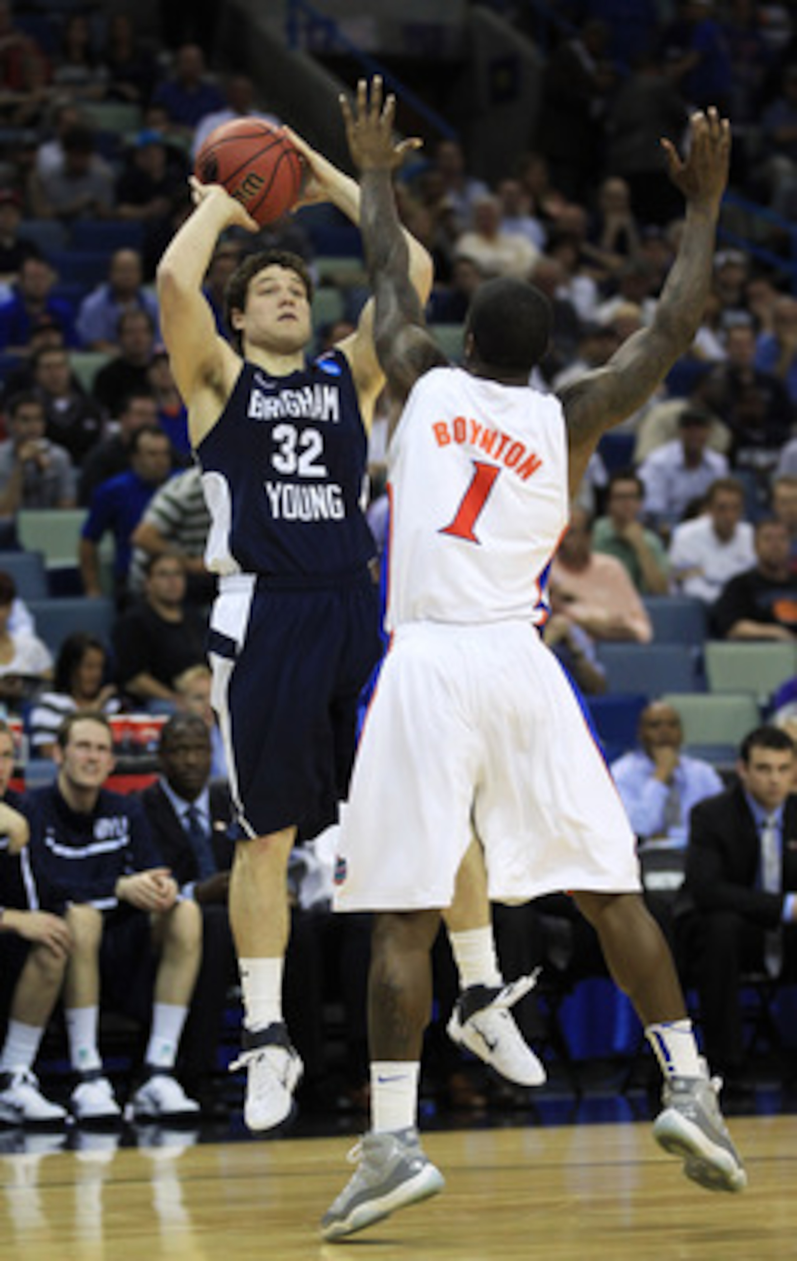 NEW ORLEANS, LA - MARCH 24:  Jimmer Fredette #32 of the Brigham Young Cougars shoots over Kenny Boynton #1 of the Florida Gators in the second half during the Southeast regional of the 2011 NCAA men's basketball tournament at New Orleans Arena on March 24