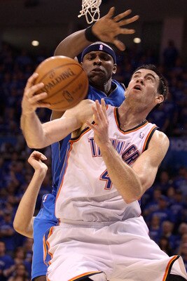 OKLAHOMA CITY, OK - MAY 23:  Nick Collison #4 of the Oklahoma City Thunder looks to shoot against Brendan Haywood #33 of the Dallas Mavericks in the second half in Game Four of the Western Conference Finals during the 2011 NBA Playoffs at Oklahoma City Ar