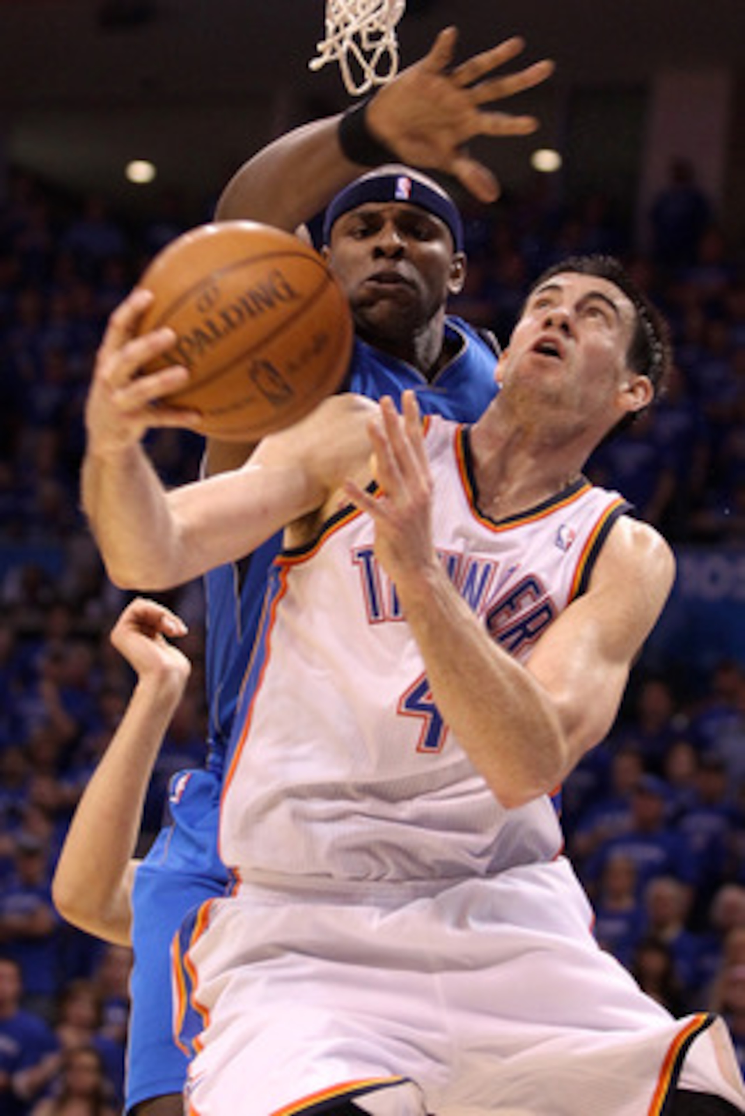 OKLAHOMA CITY, OK - MAY 23:  Nick Collison #4 of the Oklahoma City Thunder looks to shoot against Brendan Haywood #33 of the Dallas Mavericks in the second half in Game Four of the Western Conference Finals during the 2011 NBA Playoffs at Oklahoma City Ar