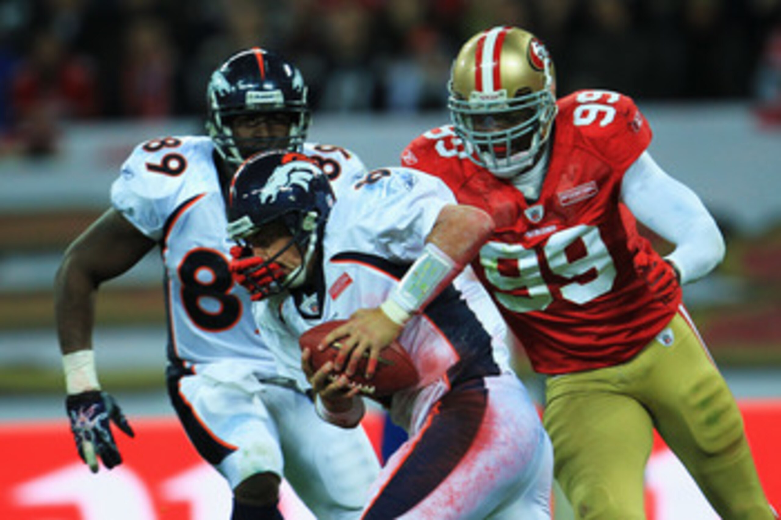 LONDON, ENGLAND - OCTOBER 31:  Manny Lawson #99 of San Francisco 49ers sacks Kyle Orton #8 of Denver Broncos during the NFL International Series match between Denver Broncos and San Francisco 49ers at Wembley Stadium on October 31, 2010 in London, England