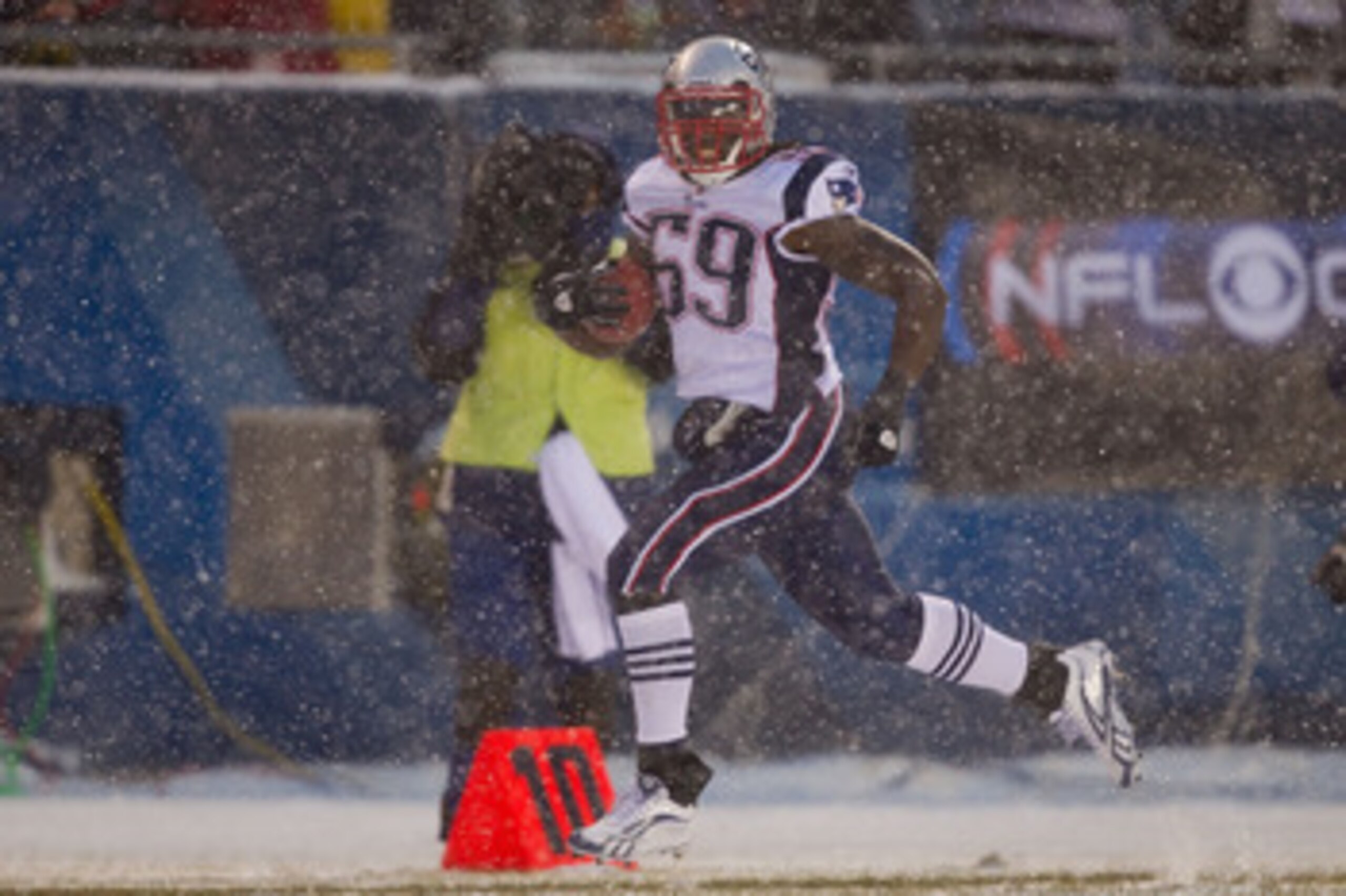 CHICAGO, IL - DECEMBER 12: Gary Guyton #59 of the New England Patriots returns a fumble for a touchdown against the Chicago Bears at Soldier Field on December 12, 2010 in Chicago, Illinois.  The Patriots beat the Bears 36-7.  (Photo by Dilip Vishwanat/Get