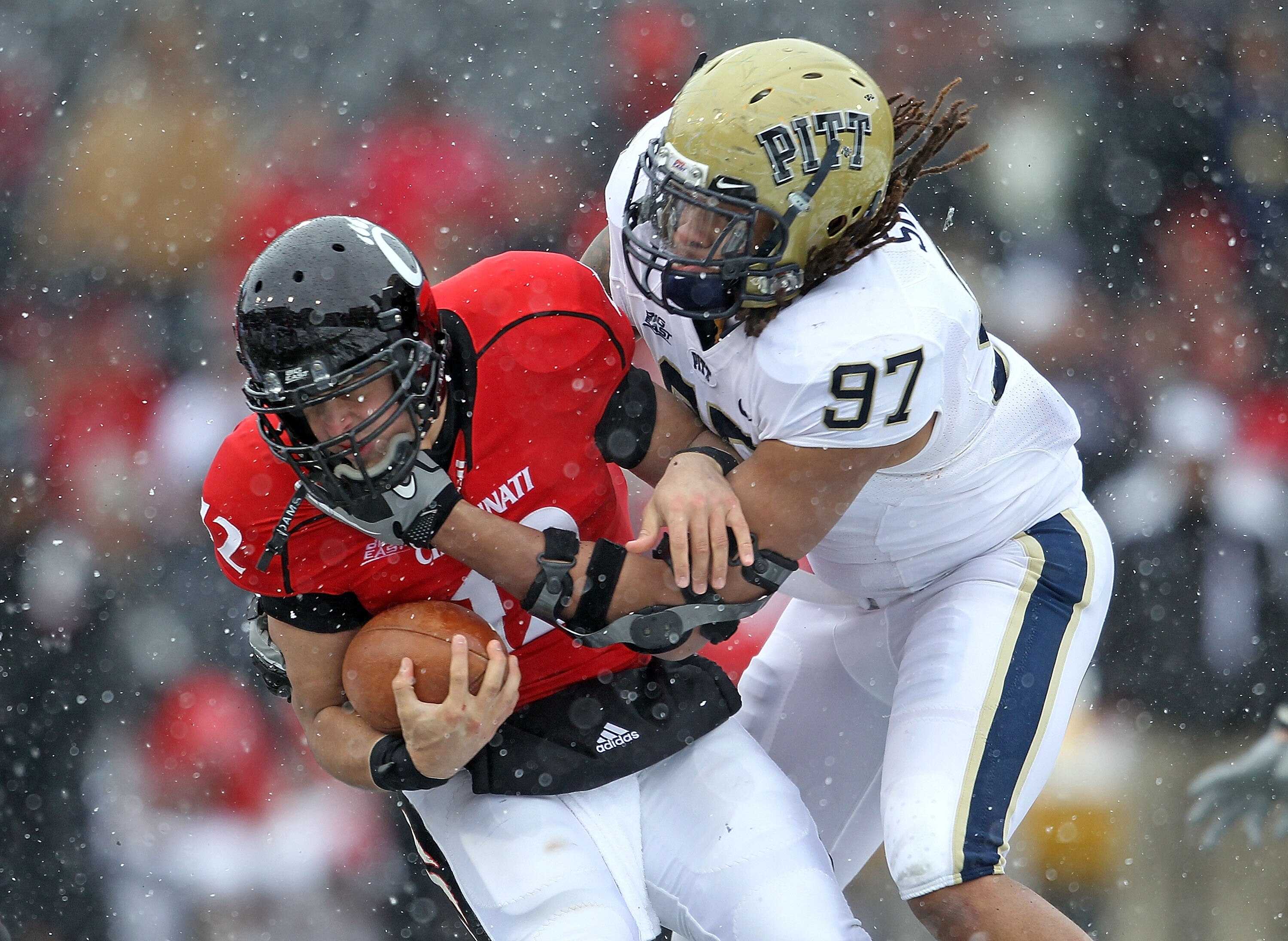 CINCINNATI, OH - DECEMBER 04:  Jabaal Sheard #97 of the Pittsburgh Panthers tackles Zach Collaros #12 of the Cincinnati Bearcats during the Big East Conference game against at Nippert Stadium on December 4, 2010 in Cincinnati, Ohio.  Pittsburgh won 28-10.