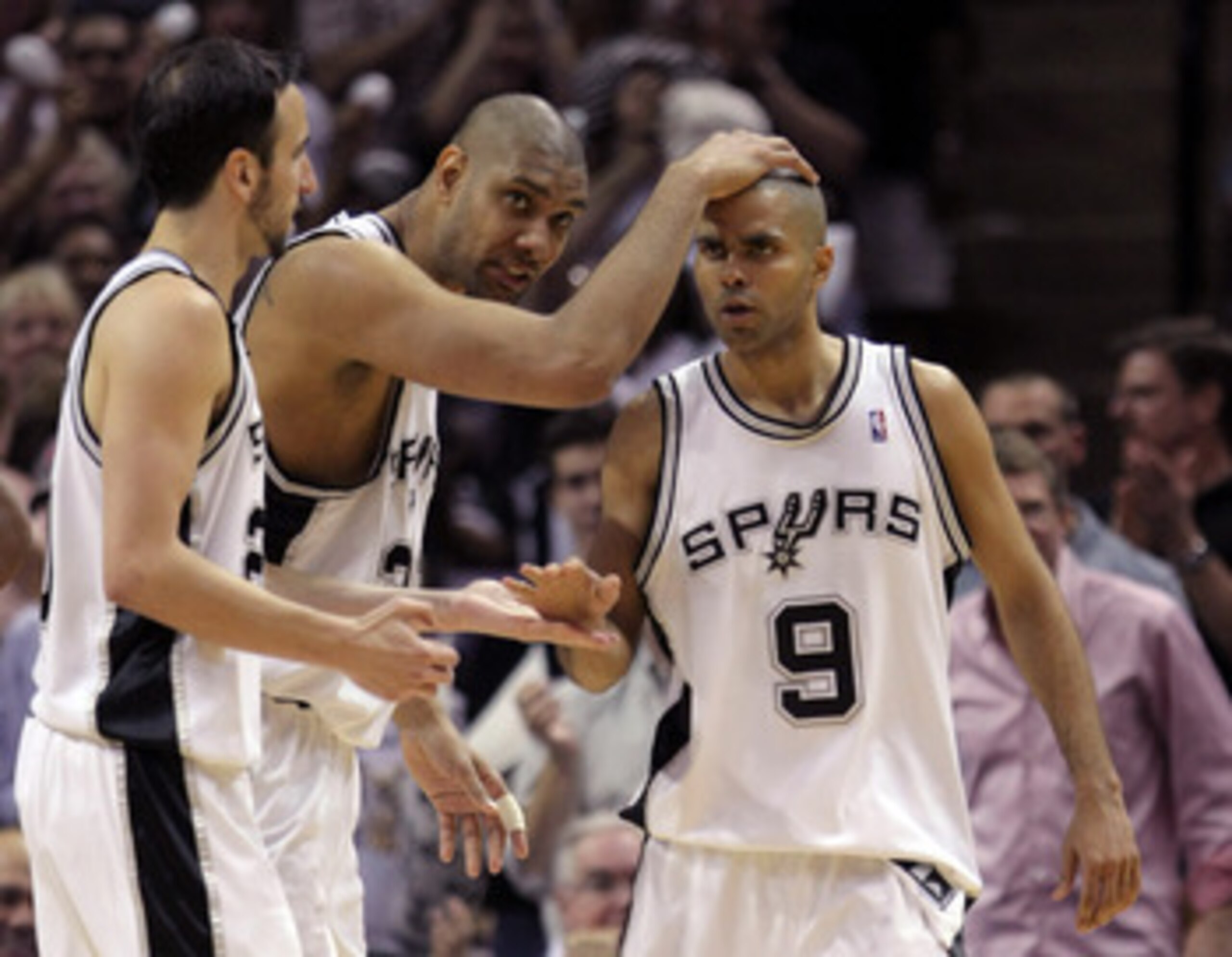 SAN ANTONIO - APRIL 29:  Tony Parker #9 of the San Antonio Spurs celebrates his basket in the final seconds of the first half with Tim Duncan #21 and  Manu Ginobili #20 against the Phoenix Suns in Game Five of the Western Conference Quarterfinals during t