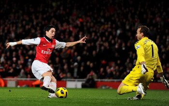 LONDON, ENGLAND - DECEMBER 04: Samir Nasri of Arsenal takes the ball past Fulham goalkeeper Mark Schwarzer to score the winning goal during the Barclays Premier League match between Arsenal and Fulham at the Emirates Stadium on December 4, 2010 in London,