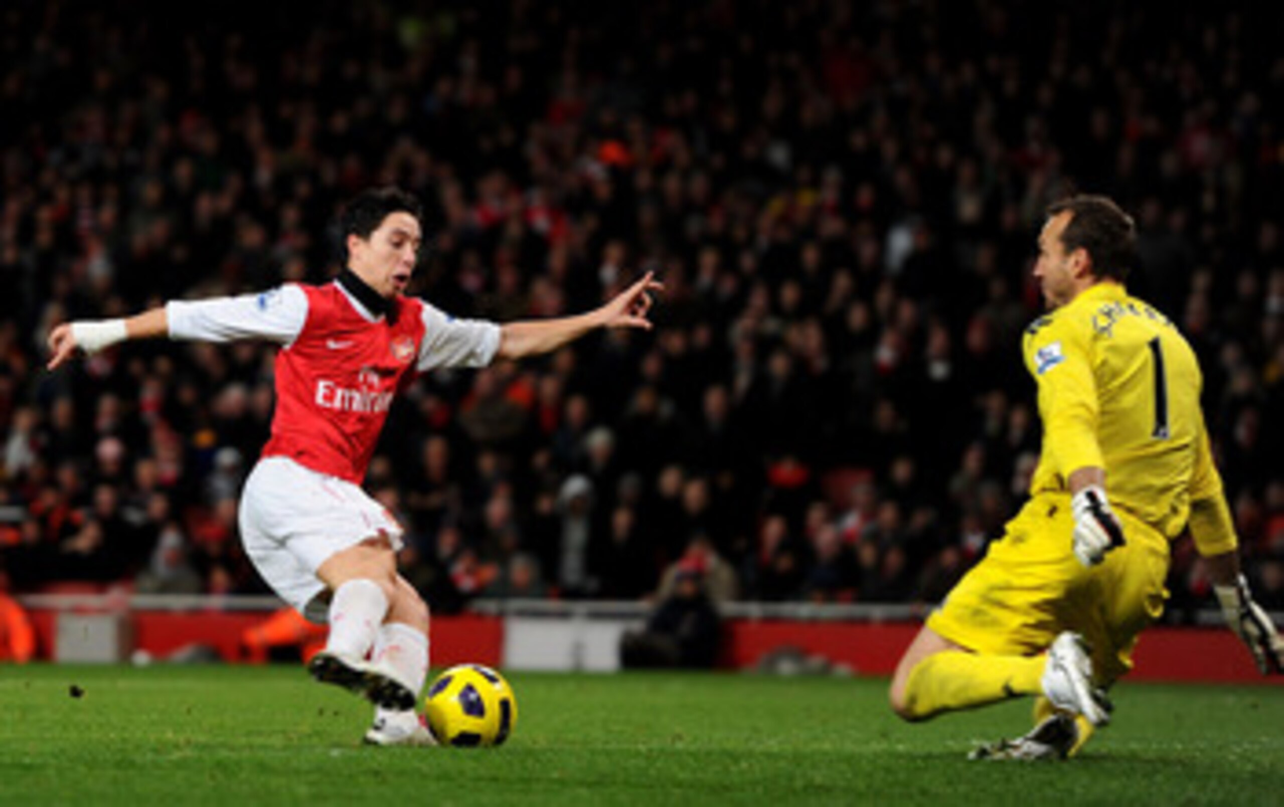 LONDON, ENGLAND - DECEMBER 04: Samir Nasri of Arsenal takes the ball past Fulham goalkeeper Mark Schwarzer to score the winning goal during the Barclays Premier League match between Arsenal and Fulham at the Emirates Stadium on December 4, 2010 in London,