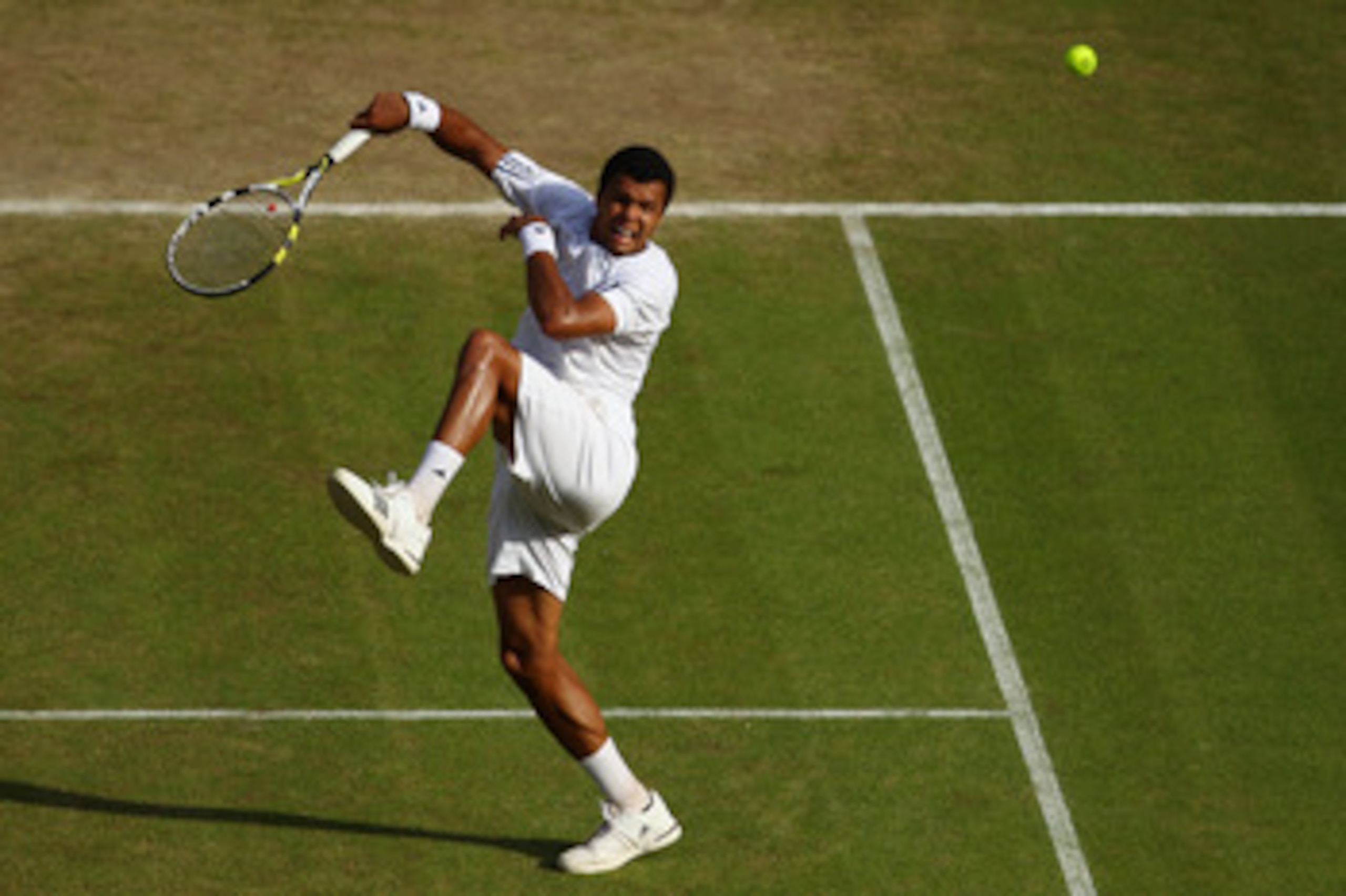 LONDON, ENGLAND - JUNE 30:  Jo-Wilfred Tsonga of France plays a shot during his Quarter Final match against Andy Murray of Great Britain on Day Nine of the Wimbledon Lawn Tennis Championships at the All England Lawn Tennis and Croquet Club on June 30, 201