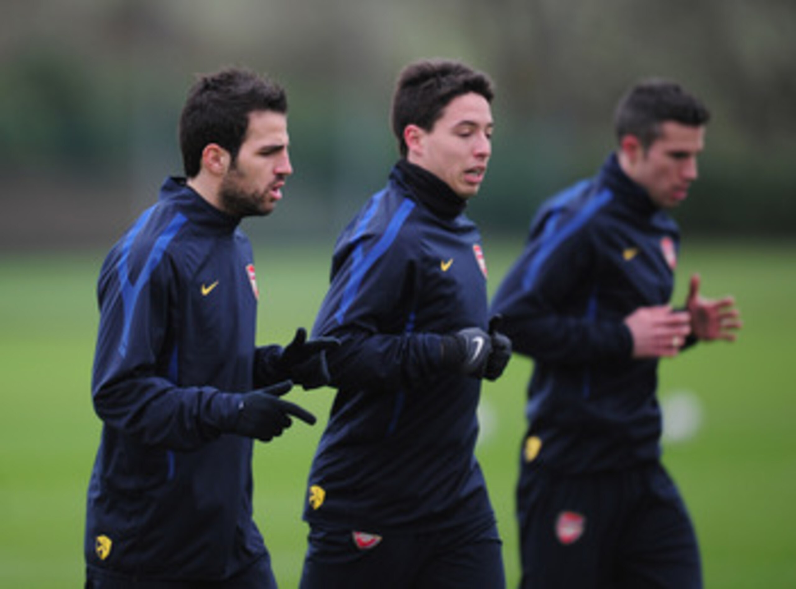 ST ALBANS, ENGLAND - FEBRUARY 15:  Cesc Fabregas, Samir Nasri and Robin Van Persie of Arsenal warm-up during training at London Colney on February 15, 2011 in St Albans, England.  (Photo by Shaun Botterill/Getty Images)