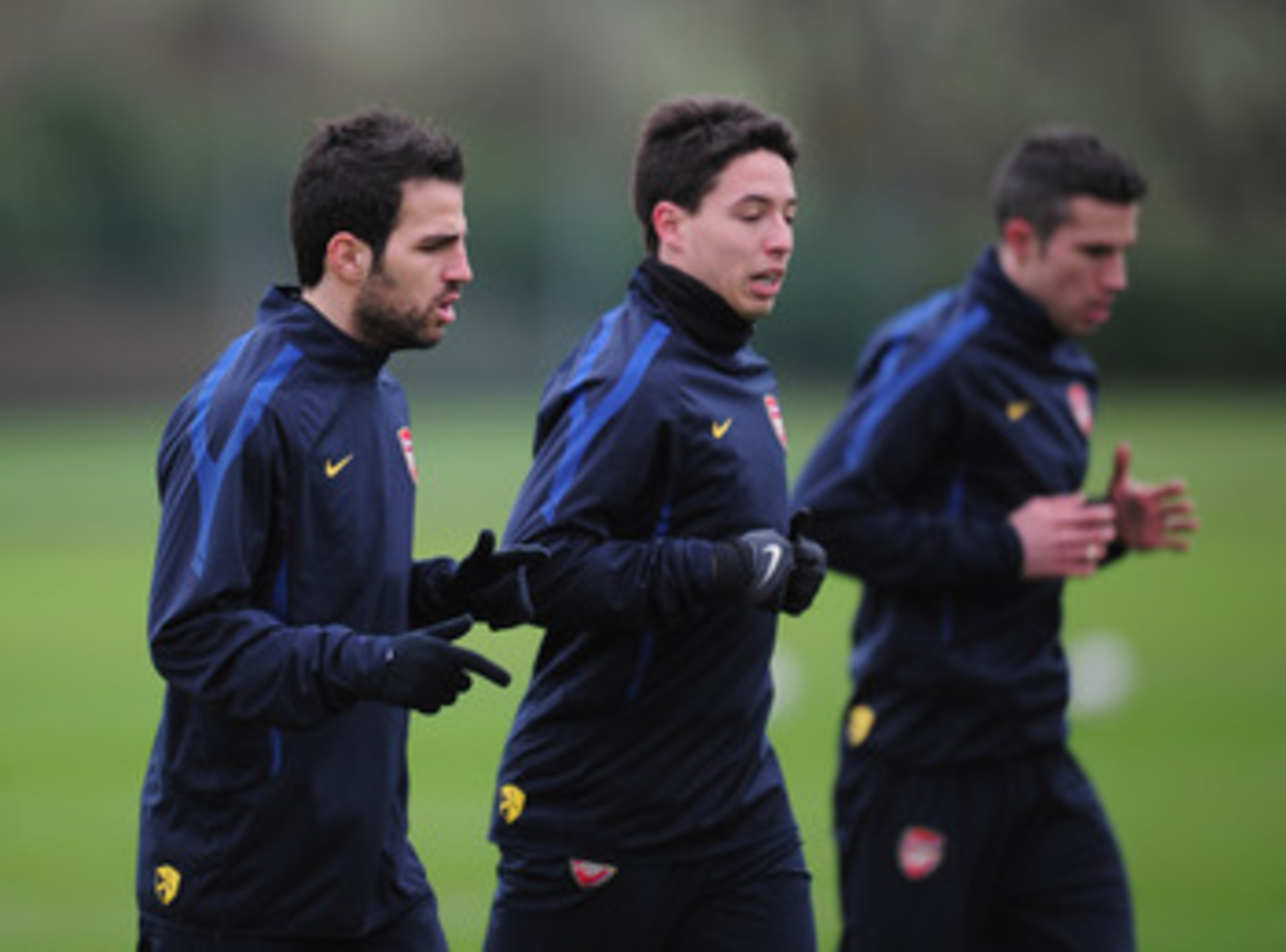 ST ALBANS, ENGLAND - FEBRUARY 15:  Cesc Fabregas, Samir Nasri and Robin Van Persie of Arsenal warm-up during training at London Colney on February 15, 2011 in St Albans, England.  (Photo by Shaun Botterill/Getty Images)