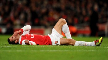 LONDON, ENGLAND - DECEMBER 04:  Robin Van Persie of Arsenal receives medical treatment during the Barclays Premier League match between Arsenal and Fulham at the Emirates Stadium on December 4, 2010 in London, England.  (Photo by Mike Hewitt/Getty Images)