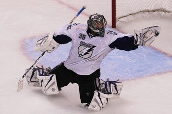 BOSTON, MA - MAY 27:  Dwayne Roloson #35 of the Tampa Bay Lightning reaches for a glove save in Game Seven of the Eastern Conference Finals during the 2011 NHL Stanley Cup Playoffs at TD Garden on May 27, 2011 in Boston, Massachusetts.  (Photo by Jim Roga