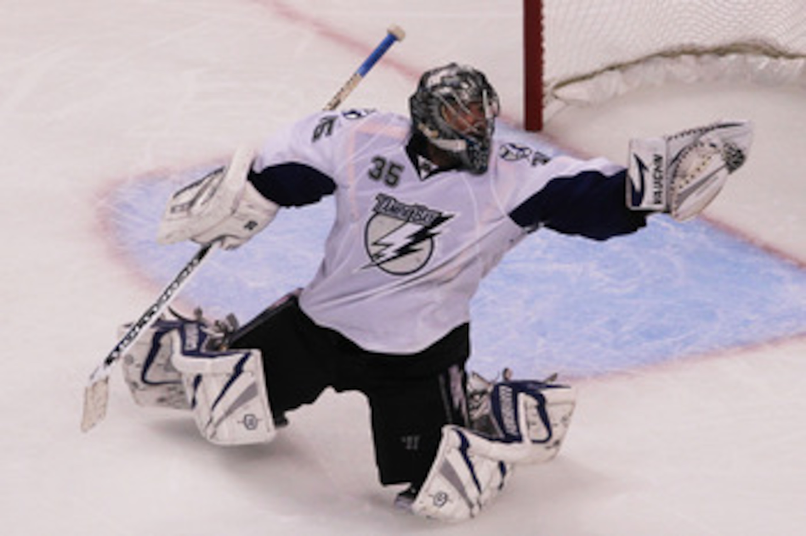 BOSTON, MA - MAY 27:  Dwayne Roloson #35 of the Tampa Bay Lightning reaches for a glove save in Game Seven of the Eastern Conference Finals during the 2011 NHL Stanley Cup Playoffs at TD Garden on May 27, 2011 in Boston, Massachusetts.  (Photo by Jim Roga