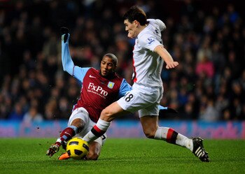 BIRMINGHAM, ENGLAND - JANUARY 22:  Ashley Young of Aston Villa and former teammate Gareth Barry of Manchester City compete for the ball during the Barclays Premier League match between Aston Villa and Manchester City at Villa Park on January 22, 2011 in B