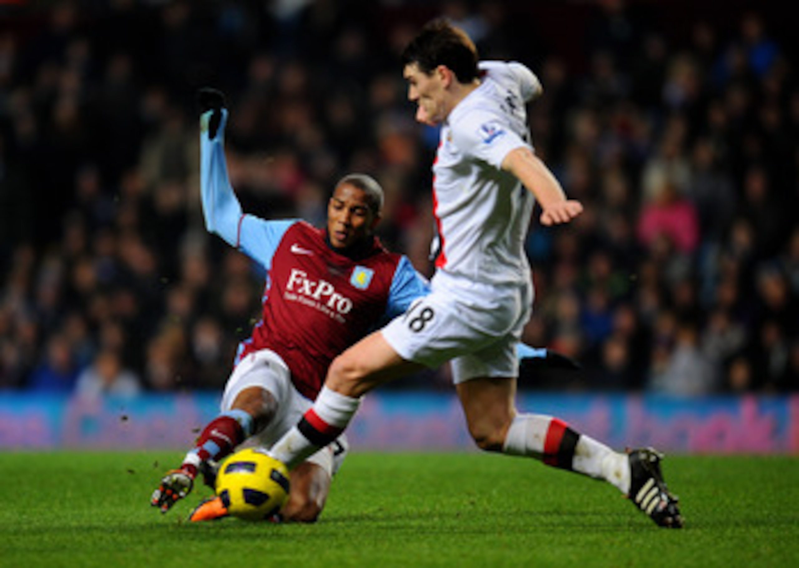 BIRMINGHAM, ENGLAND - JANUARY 22:  Ashley Young of Aston Villa and former teammate Gareth Barry of Manchester City compete for the ball during the Barclays Premier League match between Aston Villa and Manchester City at Villa Park on January 22, 2011 in B