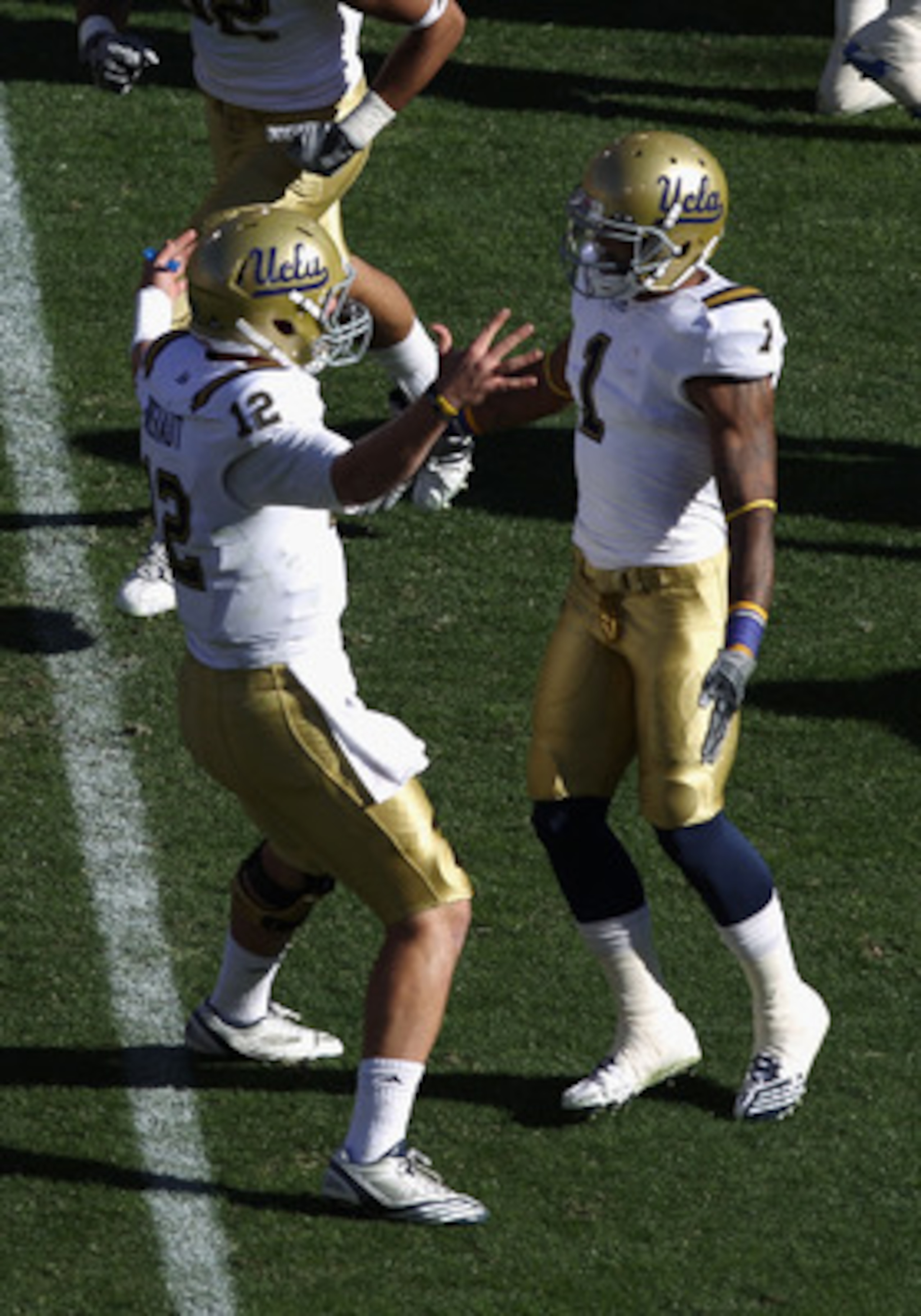 TEMPE, AZ - NOVEMBER 26:  Quarterback Richard Brehaut #12 of the UCLA Bruins celebrates with Randall Carroll #1 during the college football game against the Arizona State Sun Devils at Sun Devil Stadium on November 26, 2010 in Tempe, Arizona. The Sun Devi
