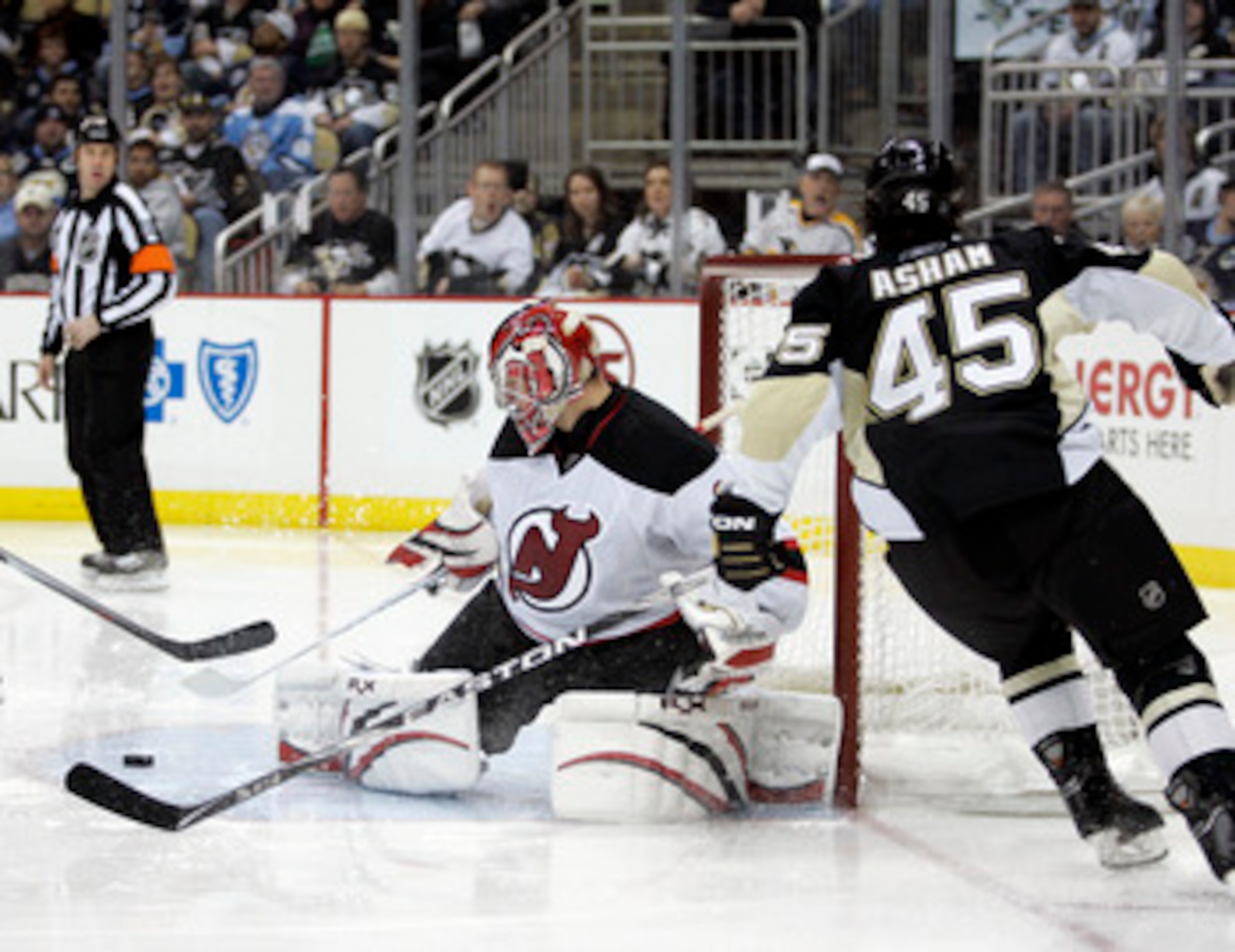 PITTSBURGH, PA - APRIL 05:  Johan Hedberg #1 of the New Jersey Devils makes a save on Arron Asham #45 of the Pittsburgh Penguins at Consol Energy Center on April 5, 2011 in Pittsburgh, Pennsylvania.  The Penguins defeated the Devils 4-2.  (Photo by Justin