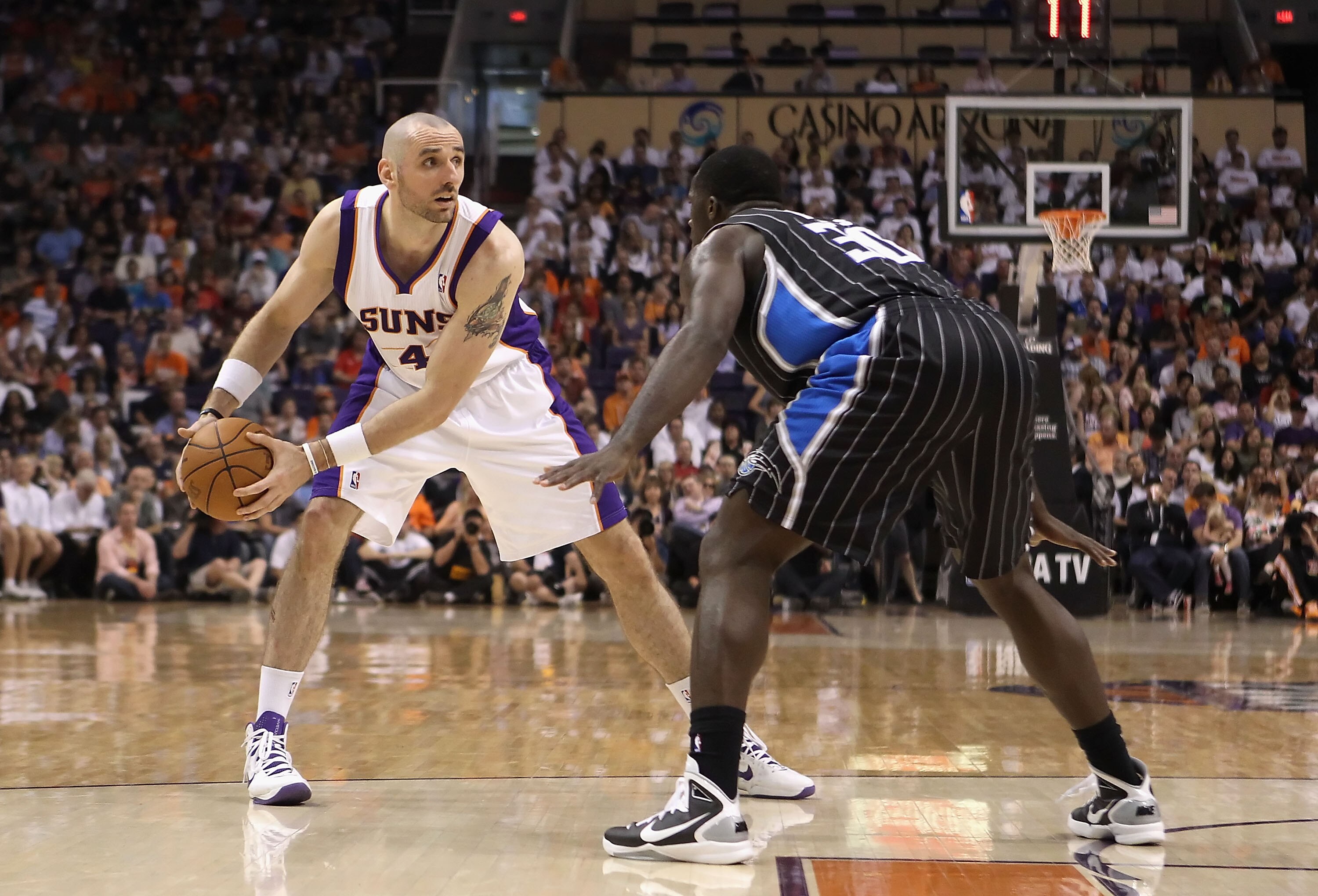 PHOENIX, AZ - MARCH 13:  Marcin Gortat #4 of the Phoenix Suns looks to pass the ball against the Orlando Magic during the NBA game at US Airways Center on March 13, 2011 in Phoenix, Arizona.  NOTE TO USER: User expressly acknowledges and agrees that, by d
