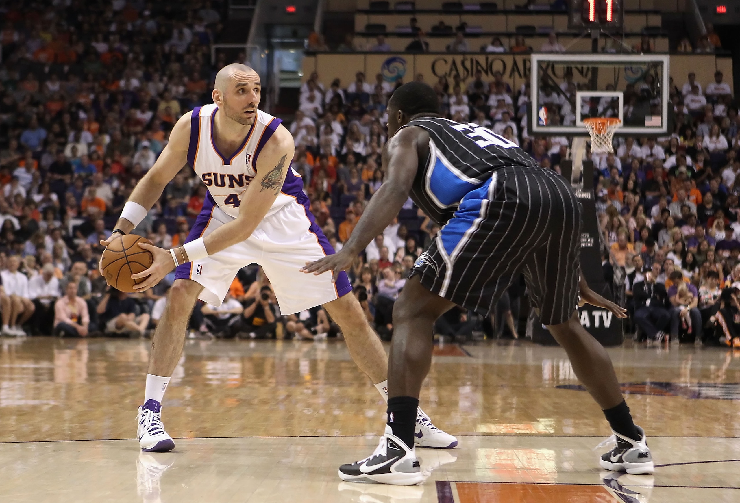 PHOENIX, AZ - MARCH 13:  Marcin Gortat #4 of the Phoenix Suns looks to pass the ball against the Orlando Magic during the NBA game at US Airways Center on March 13, 2011 in Phoenix, Arizona.  NOTE TO USER: User expressly acknowledges and agrees that, by d