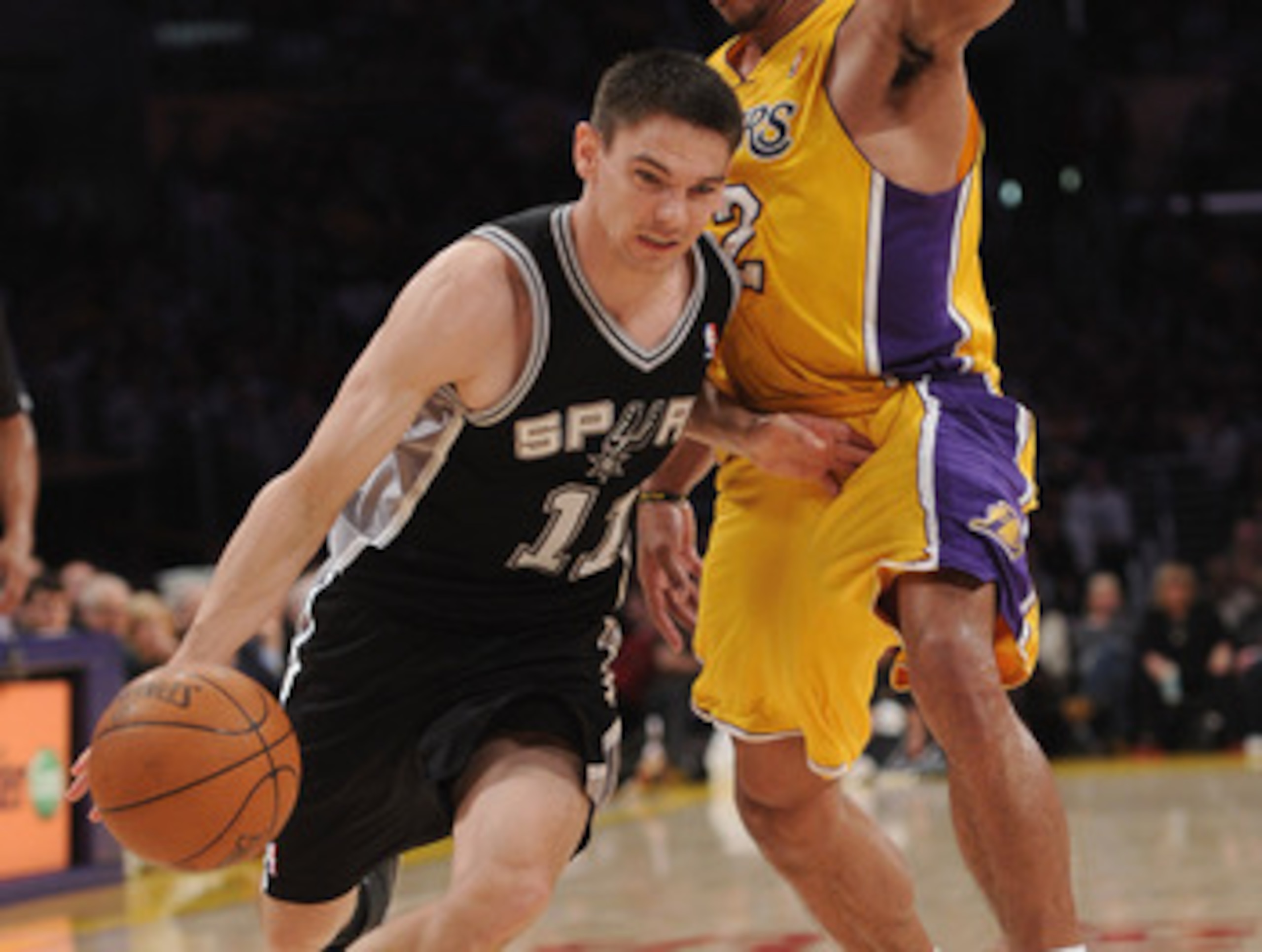 LOS ANGELES, CA - APRIL 12:  Chris Quinn #11 of the San Antonio Spurs drives on Shannon Brown #12 of the Los Angeles Lakers during the game at Staples Center on April 12, 2011 in Los Angeles, California.  NOTE TO USER: User expressly acknowledges and agre