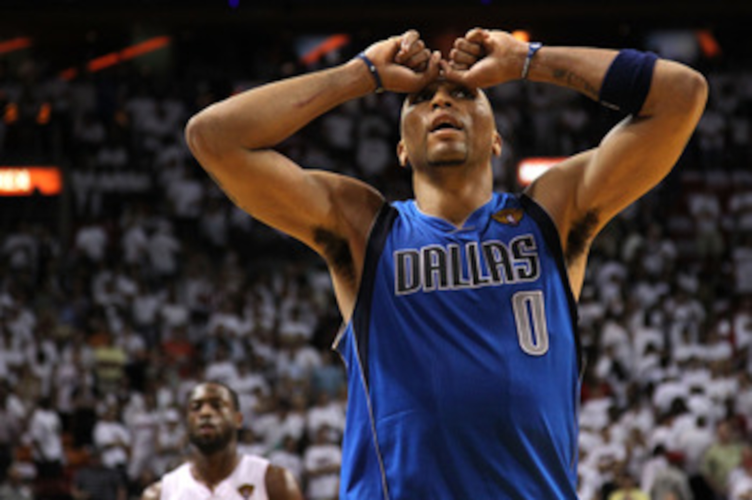 MIAMI, FL - JUNE 12:  Shawn Marion #0 of the Dallas Mavericks reacts as Dwyane Wade #3 of the Miami Heat looks on in the background in Game Six of the 2011 NBA Finals at American Airlines Arena on June 12, 2011 in Miami, Florida. THe Mavericks won 105-95.
