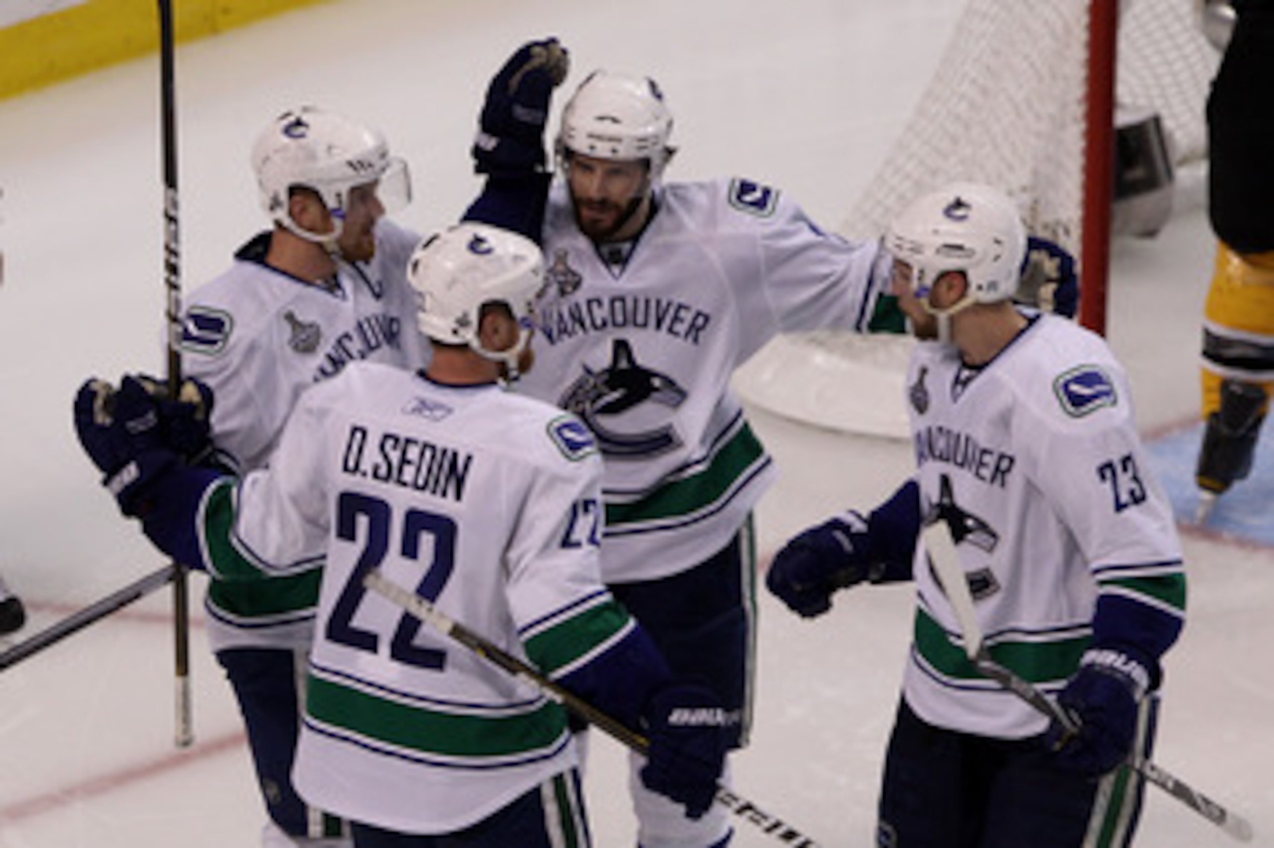 BOSTON, MA - JUNE 13: Ryan Kesler #17 of the Vancouver Canucks celebrates with Henrik Sedin #33, Daniel Sedin #22 and Alexander Edler #23 against the Boston Bruins during Game Six of the 2011 NHL Stanley Cup Final at TD Garden on June 13, 2011 in Boston, BOSTON, MA - JUNE 13: Ryan Kesler #17 of the Vancouver Canucks celebrates with Henrik Sedin #33, Daniel Sedin #22 and Alexander Edler #23 against the Boston Bruins during Game Six of the 2011 NHL Stanley Cup Final at TD Garden on June 13, 2011 in Boston,
