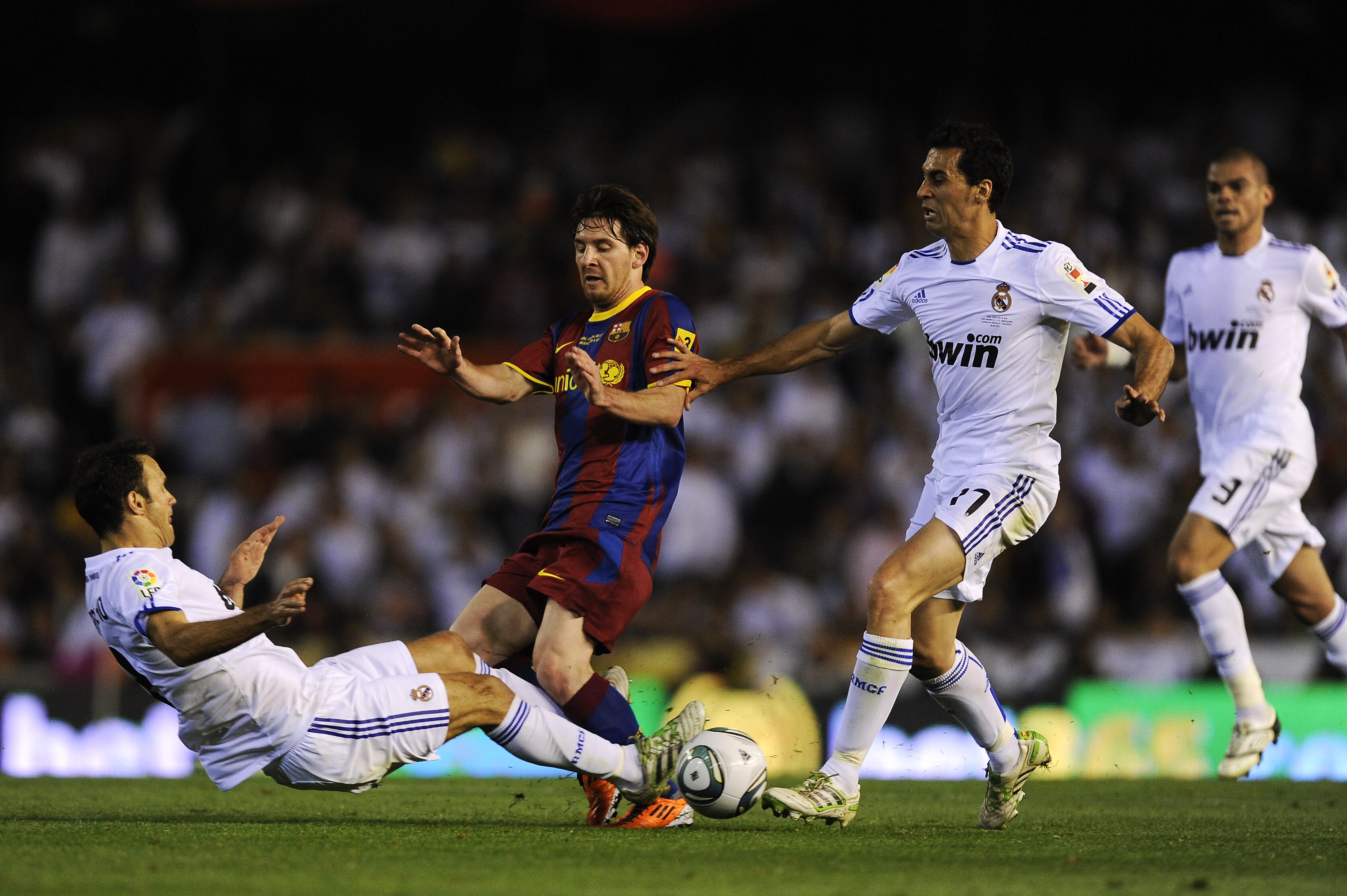 VALENCIA, SPAIN - APRIL 20: Lionel Messi of FC Barcelona (C) is tackled by Ricardo Carvalho (L) and Alvaro Arbeloa of Real Madrid (2ndR) during the Copa del Rey Final between Real Madrid and Barcelona at Estadio Mestalla on April 20, 2011 in Valencia, Spa
