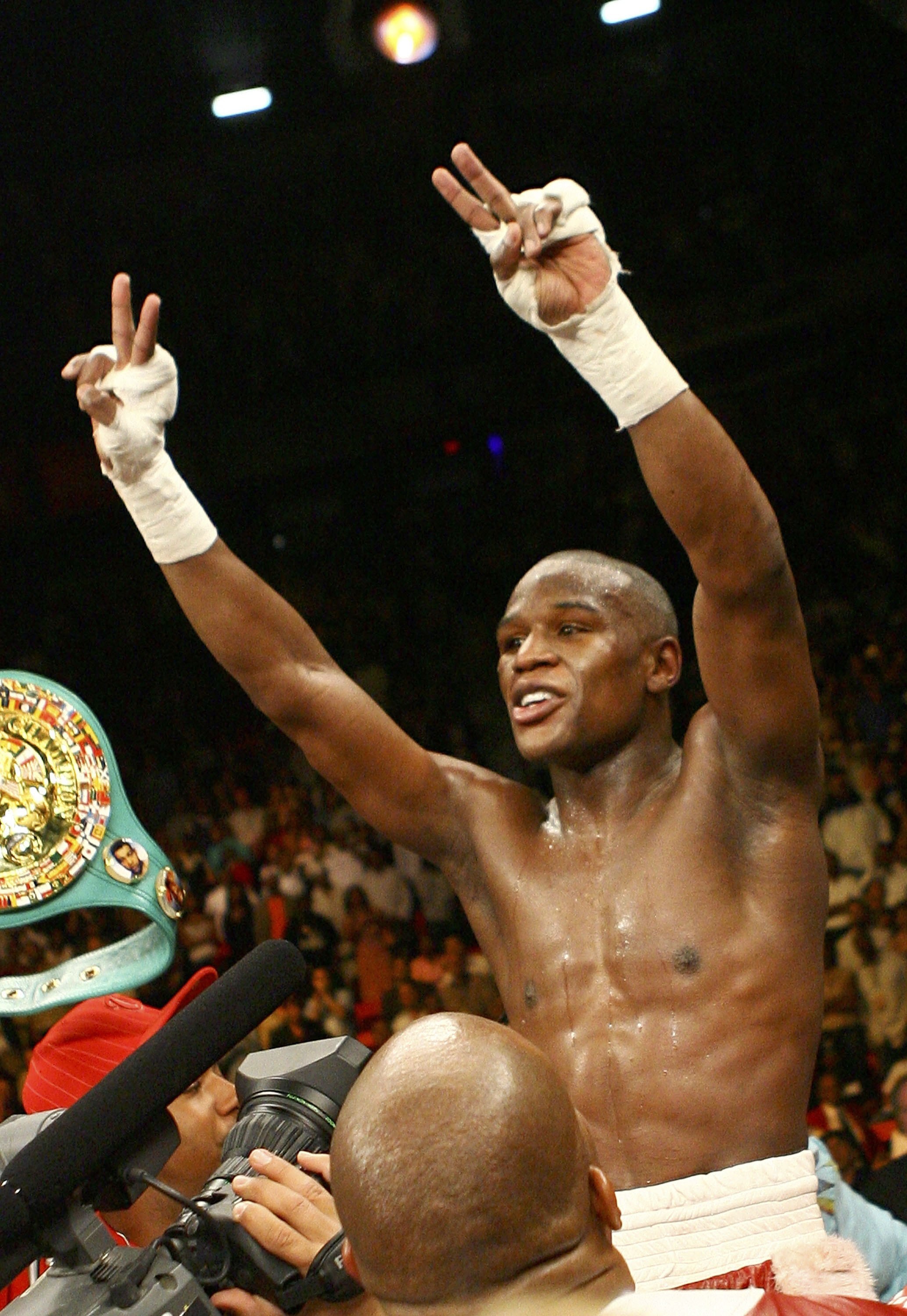 LAS VEGAS - APRIL 08:  Floyd Mayweather raises his arms in victory after winning by unanimous decision against Zab Judah during the Welterweight Championship fight at Thomas & Mack Arena on April 8, 2006 in Las Vegas, Nevada.  (Photo by Al Bello/Getty Ima