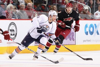 GLENDALE, AZ - JANUARY 25:  Taylor Hall #4 of the Edmonton Oilers skates with the puck past Radim Vrbata #17 of the Phoenix Coyotes during the NHL game at Jobing.com Arena on January 25, 2011 in Glendale, Arizona.  (Photo by Christian Petersen/Getty Image