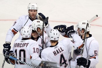 GLENDALE, AZ - JANUARY 25:  (L-R) Dustin Penner #27, Shawn Horcoff #10, Tom Gilbert #77, Taylor Hall #4 and Jeff Petry #58 of the Edmonton Oilers celebrate after Hall scored a third period power play goal against the Phoenix Coyotes during the NHL game at